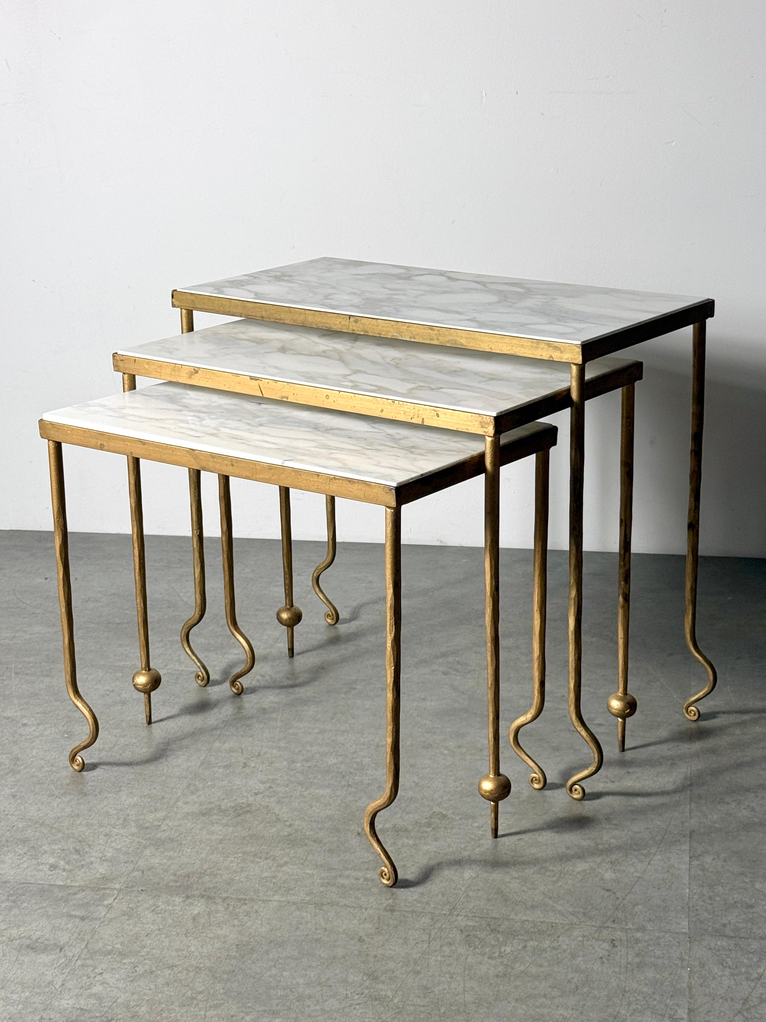 Set of 3 sculptural nesting tables attributed to René Drouet
France circa 1940s

Gilt metal frames with inset Carrara marble surfaces
Three graduated height tables with scrolled feet and orb accents that interplay when nested

largest table
24.5