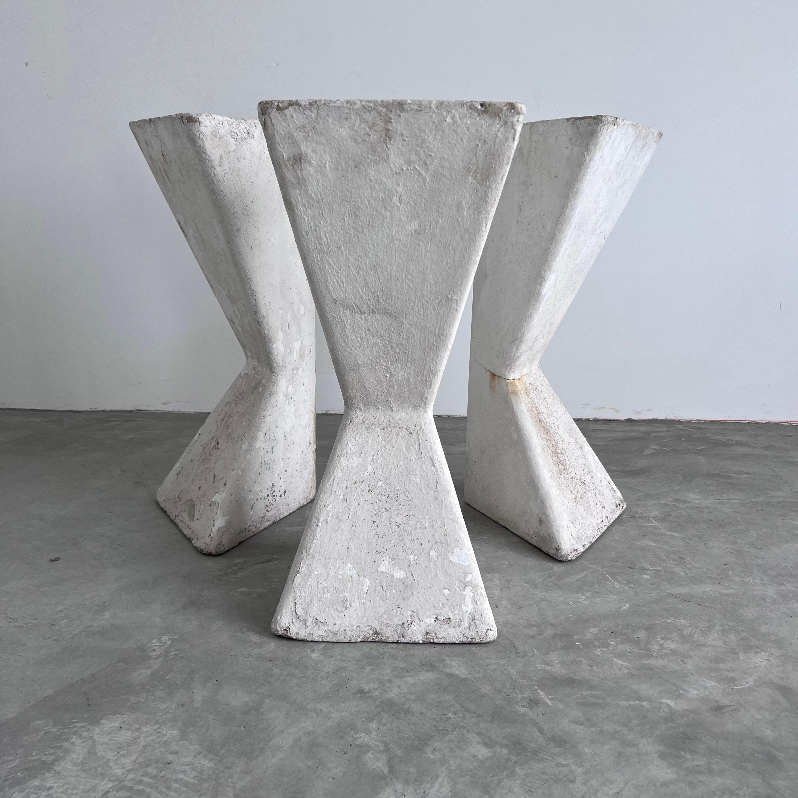 Set of 3 sculptural standing triangular concrete planters by Swiss Architect Willy Guhl. Can be placed upside down or right side. up. Each planter has a solid base to balance the weight of the planter and allow for the unique design of the planter.
