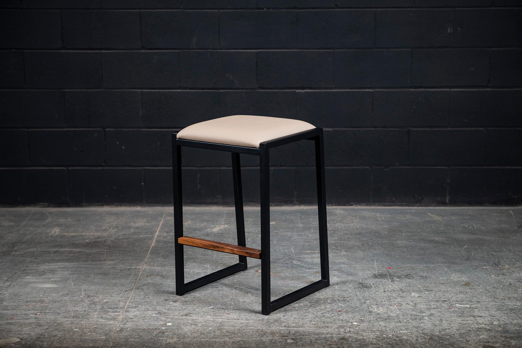 The shaker backless modern counter stool is made to order from our unique Ambrozia black textured steel tubing frame and a premium vinyl upholstered seat. Genuine leather is available in option. Inspired by the boarding ladder steps of an old boat.