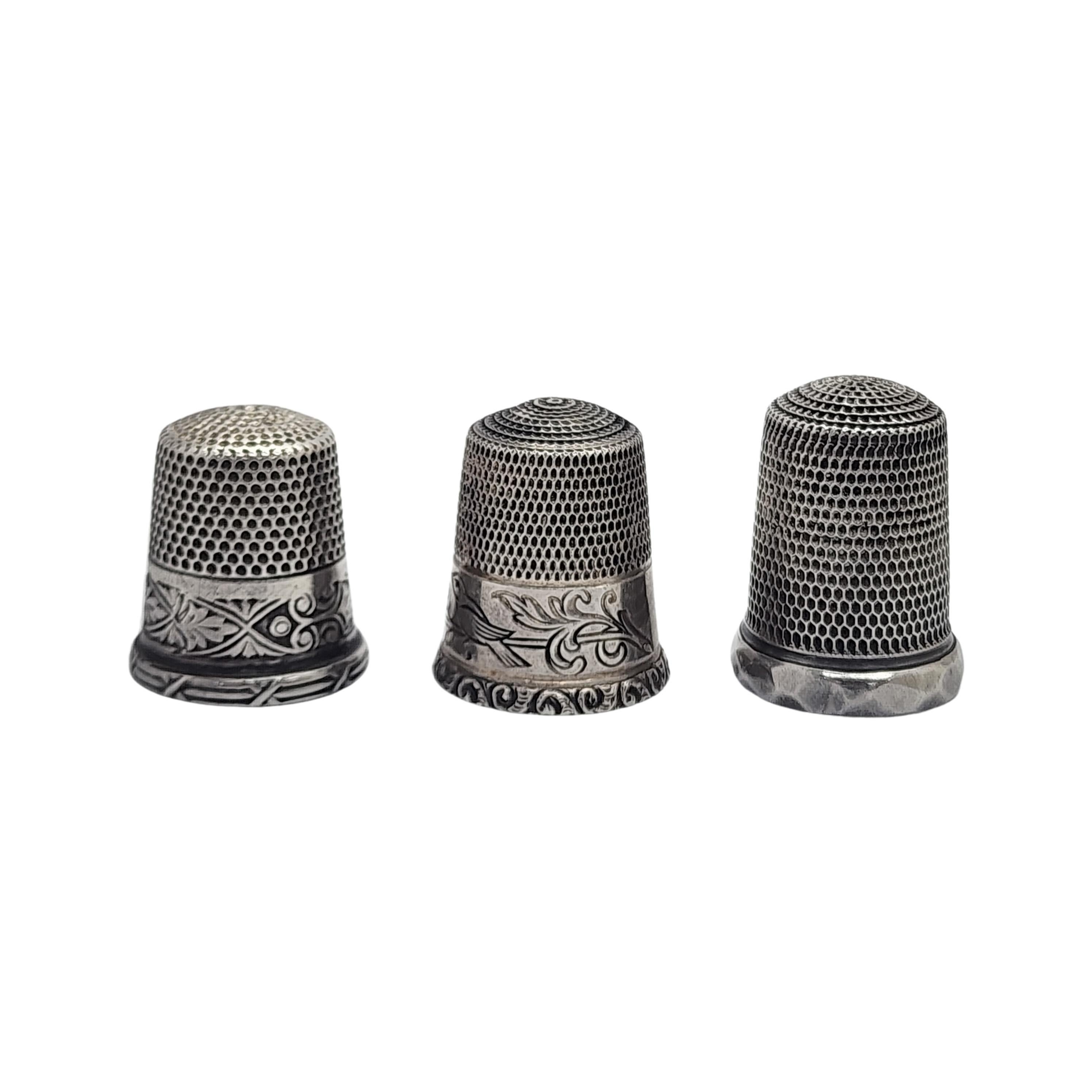 Set of 3 sterling silver thimble by Simon Bros Sizes 10 and 11.

2 thimbles feature an etched band along the bottom and 1 features a hammered rim.

The thimble with the birds is a size 11, measures approx 3/4
