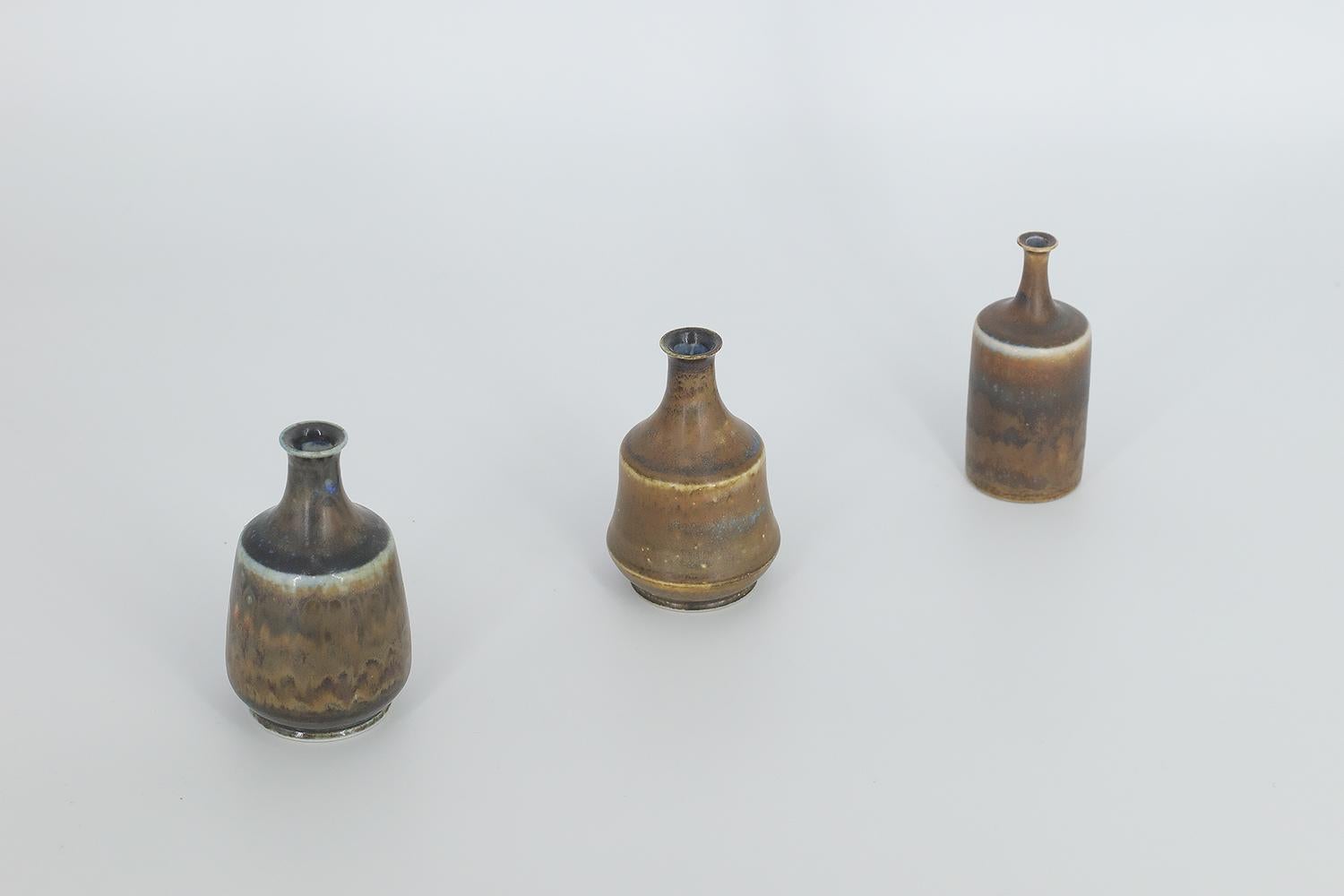 1. Height 9 cm | Width 5 cm | Depth 5 cm
2. Height 8 cm | Width 5 cm | Depth 5 cm
3. Height 8 cm | Width 3.5 cm | Depth 3.5 cm

This set of 3 miniature vases was designed by Gunnar Borg for the Swedish manufacture Höganäs Keramik during the 1960s.