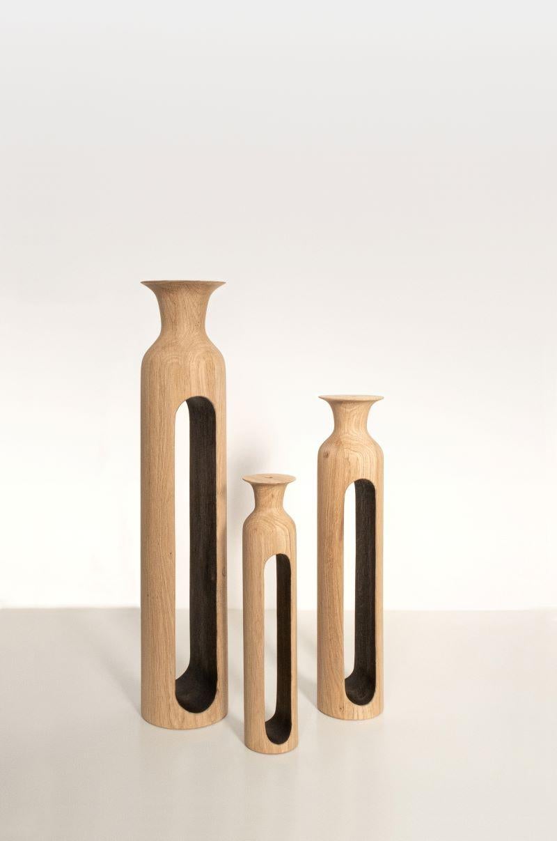 Set Of 3 Small Oak Bettoïa Vases by Alexandre Labruyère 
Current Production
Dimensions: H 28 x D 5.7 cm / H 36 x D 7.4 cm / H 49 x D 10 cm
Materials: Oak, Black Coal Wax, Natural Oil Protection.
Also Available: Ash, Sycamore, Red Oak,

All