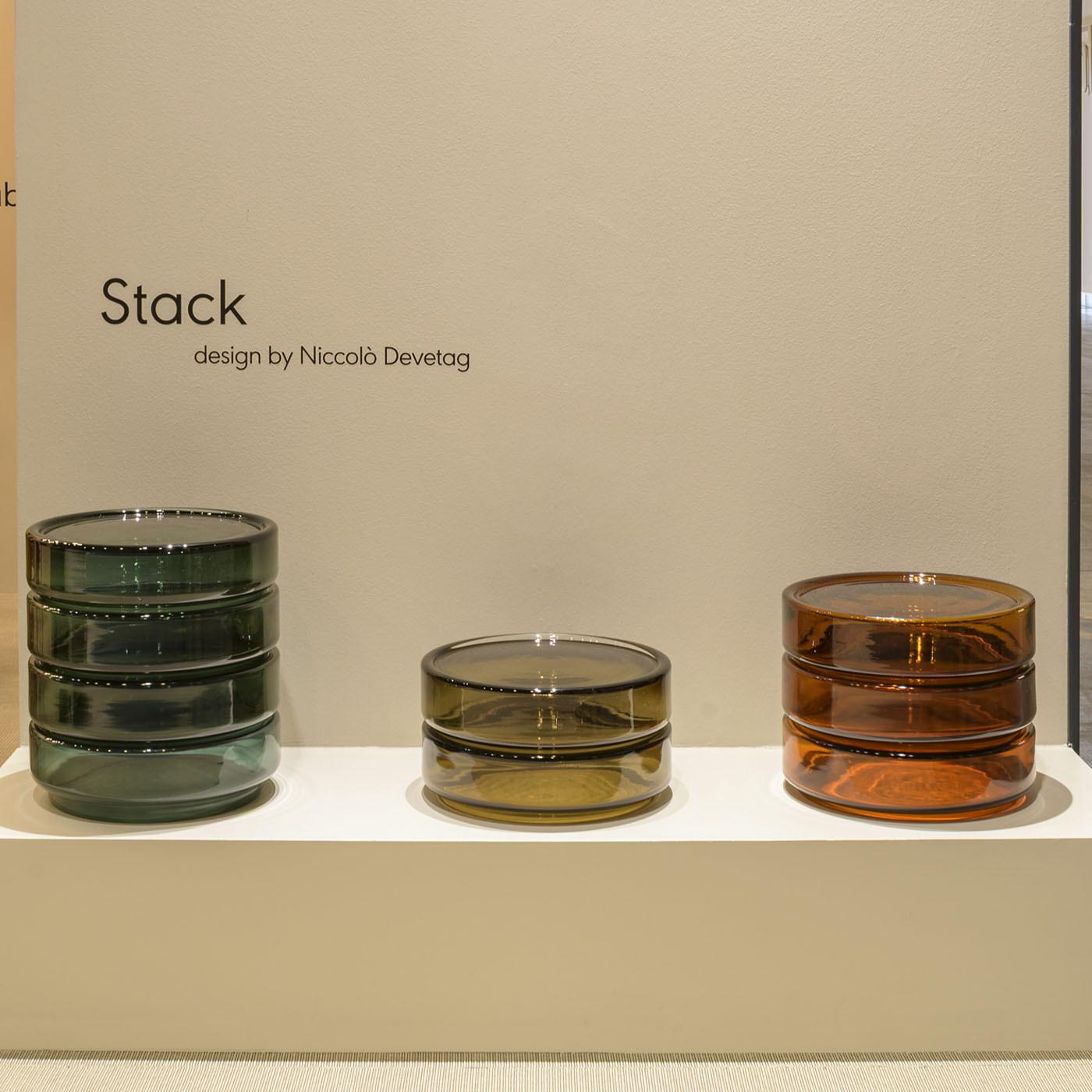 Stack 880 by Niccolò Devetag is a modular collection of colorful blown-glass coffee tables designed with flexibility in mind. Its amber hue interacts elegantly with light, producing warm reflections that enhance any space. The design allows stacking