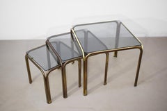 Set of 3 stackable coffee tables, brass and smoked glass, 1970s.