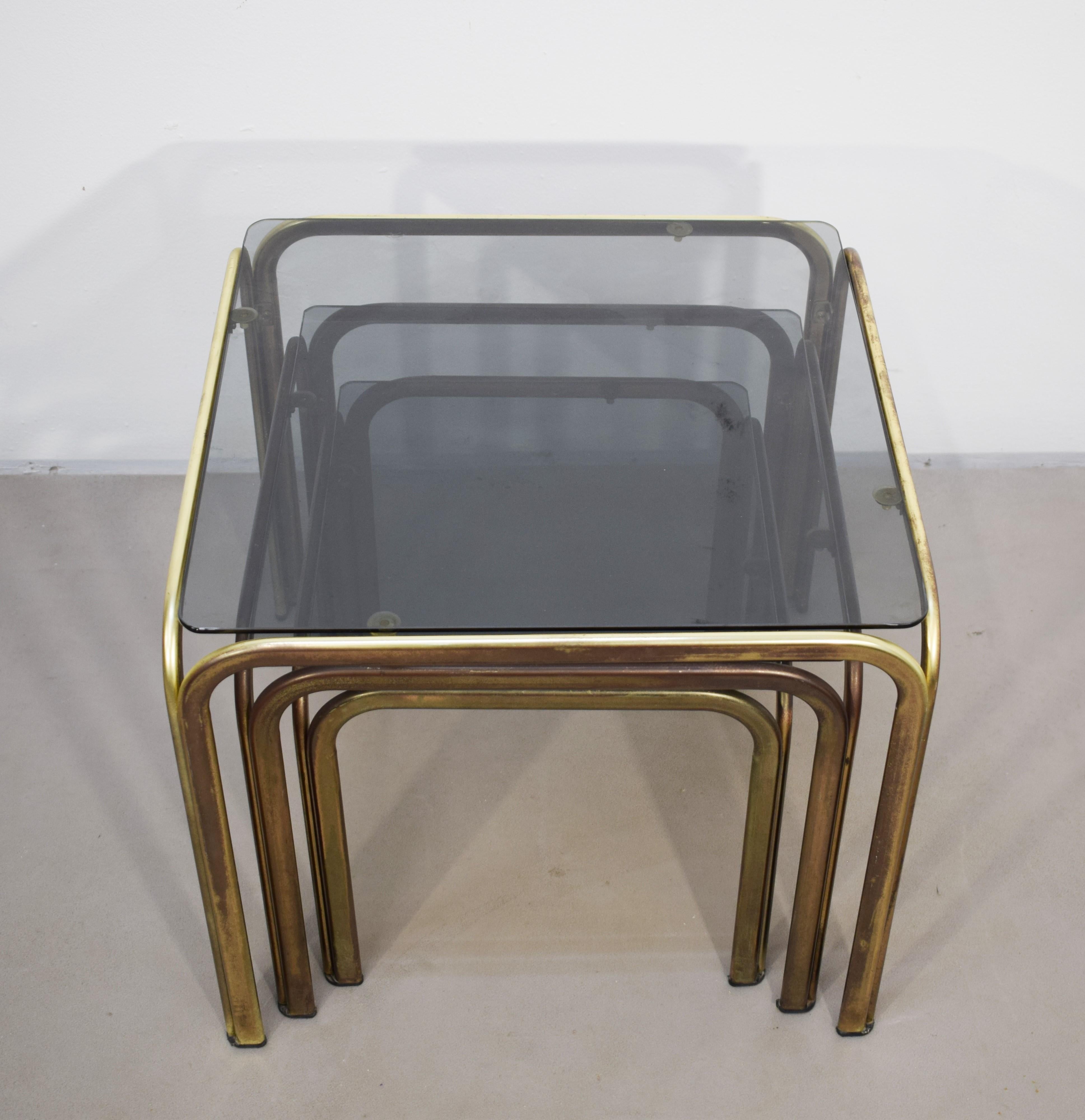 Late 20th Century Set of 3 stackable coffee tables, brass and smoked glass, 1970s. For Sale