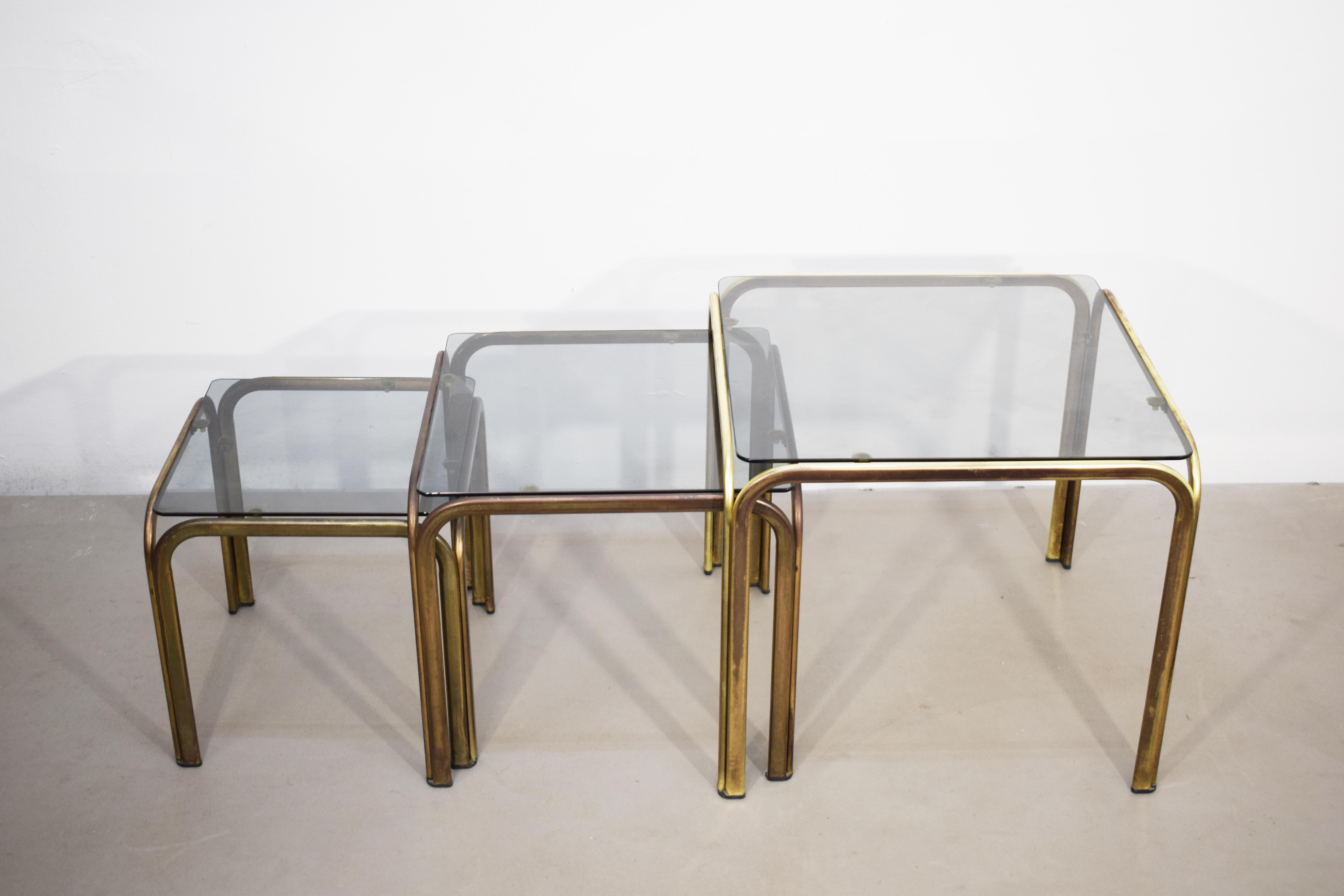 Set of 3 stackable coffee tables, brass and smoked glass, 1970s. For Sale 1