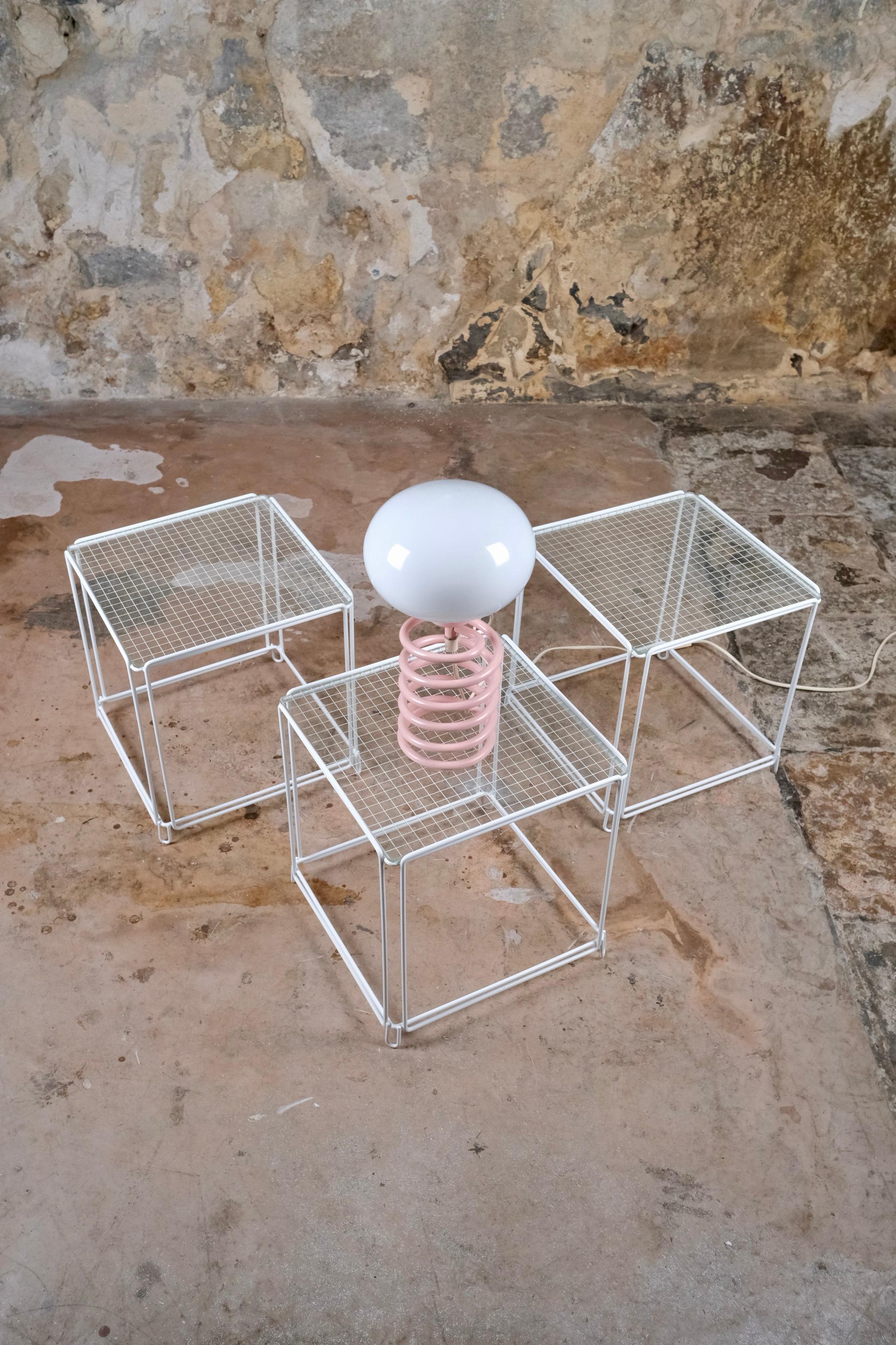 Set of 3 stackable side tables, model Isocèle, designed by Max Sauze in the 1970s in France.
The “Isocèle” model stands out with its lightweight white lacquered metal frames and its rare beveled glass tops featuring a subtle grid pattern — an