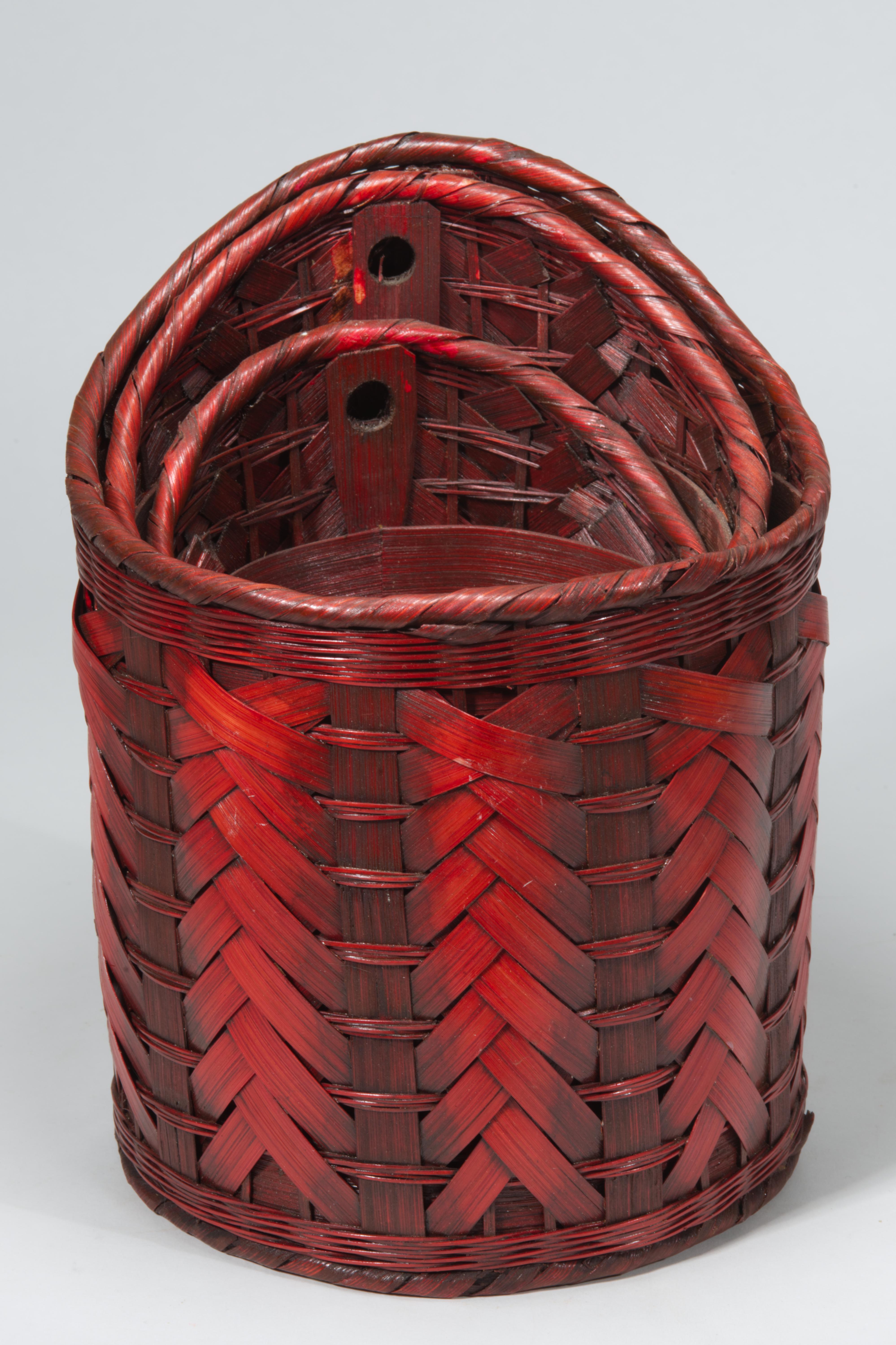 Vintage set of 3 hand-woven stacking baskets features an unusual asymmetrical rim, cylindrical shape, and complex, detailed weave. The texture is emphasized by the use of red tint that is applied with ombre effect over both outer and inner surfaces.