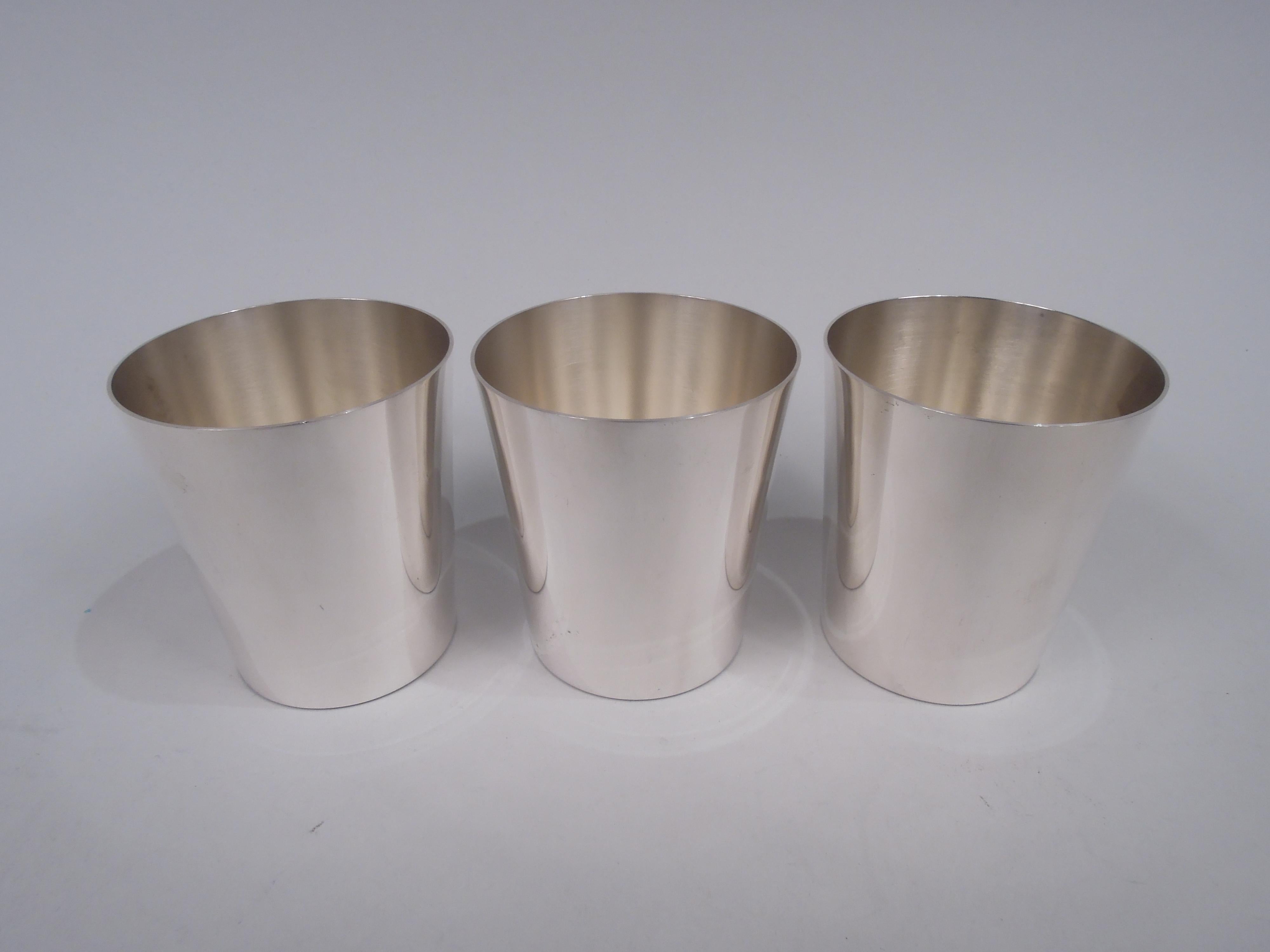 Set of 3 Midcentury Modern sterling silver tumblers. Made by Stieff in Baltimore. Each: Straight and tapering sides. Spare form and easy-grip proportions. Fully marked including maker’s stamp and no. 0707/2. Total weight: 11.7 troy ounces. 