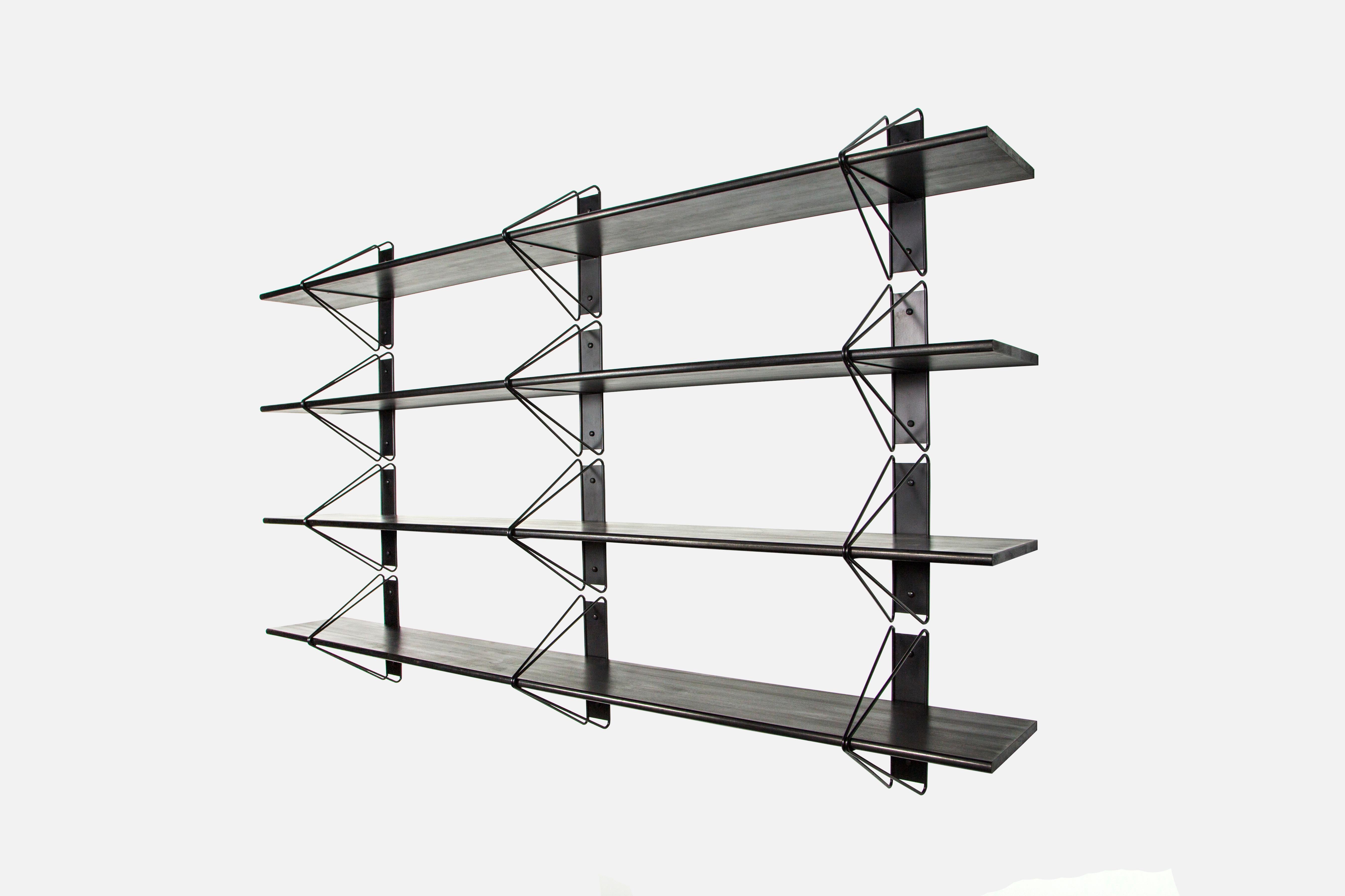 This listing is a for a custom solid black iteration of our Strut Shelving. It has 3 black shelves and 6 black brackets. It was used in our office as a display piece for a little while so there is some very minor signs of use on the brackets. The