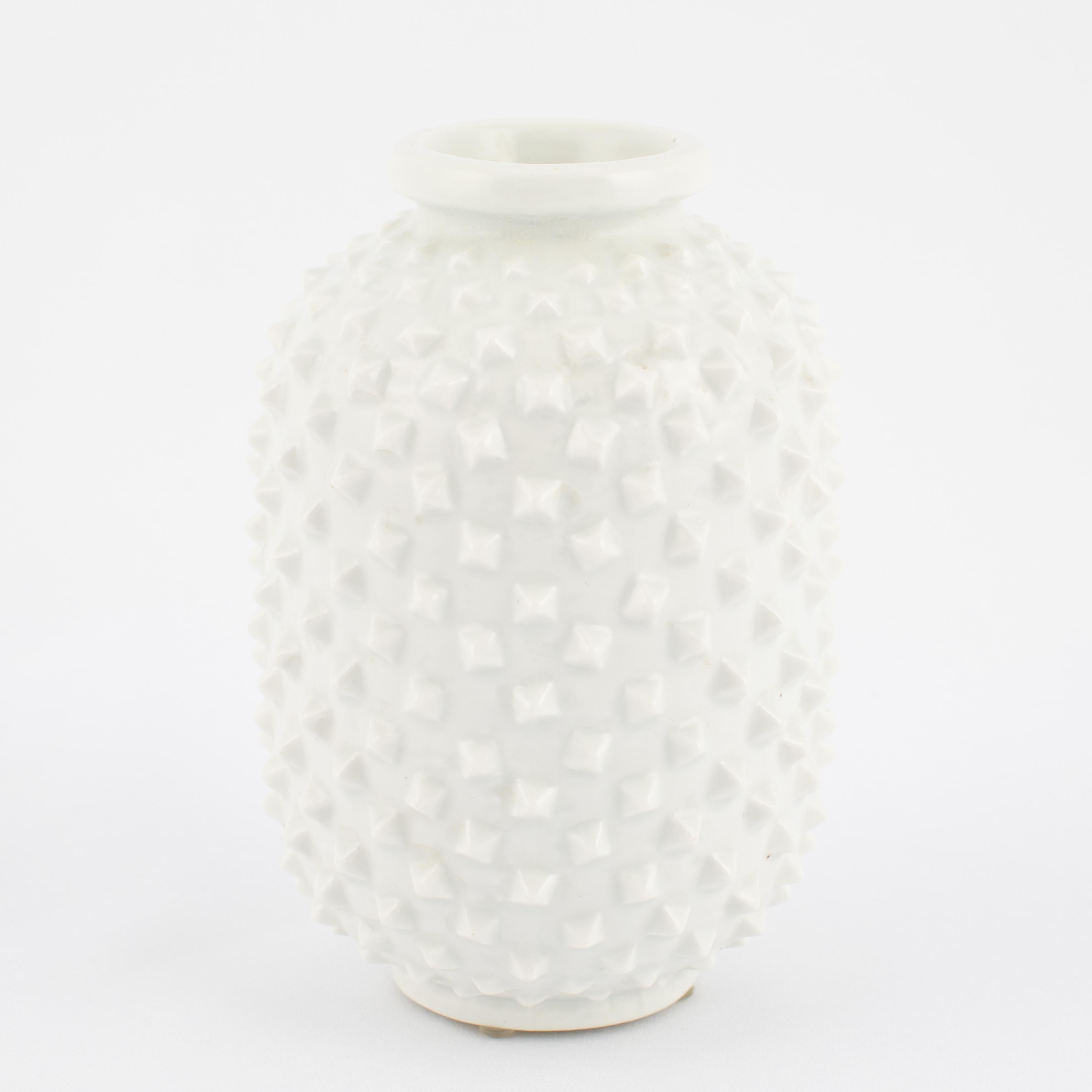 Striking trio of cylindrical vases covered in raised studs in a glossy white glaze, by Gunnar Nylund (1904-1997) for Rörstrand, designed in 1951. Each stamped on the bottom with the Rörstrand 