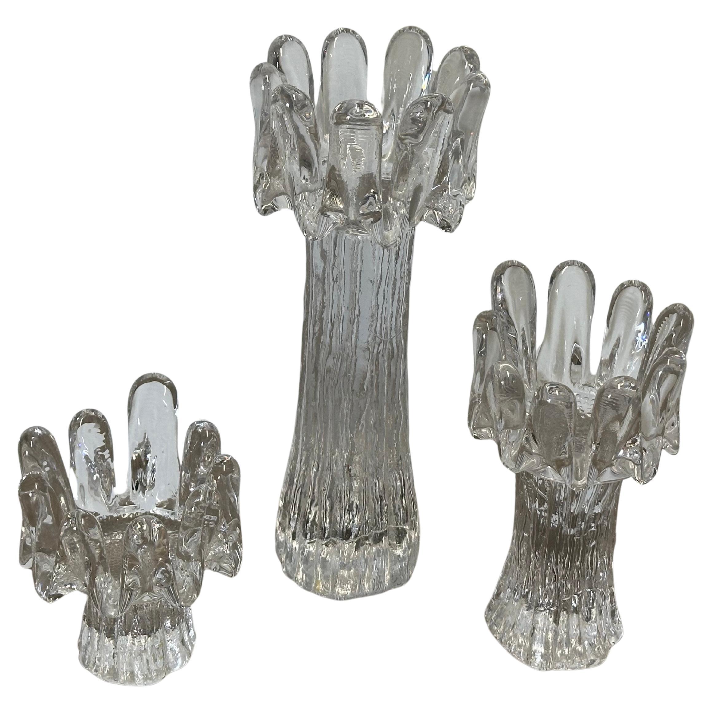 Set of three vintage Swedish crystal sunflower candlesticks by Göran Wärff for Kosta Boda, circa 1970s.   This beautiful trio of clear glass candleholders is in good vintage condition with no chips or cracks, measuring approximately:

Large 11
