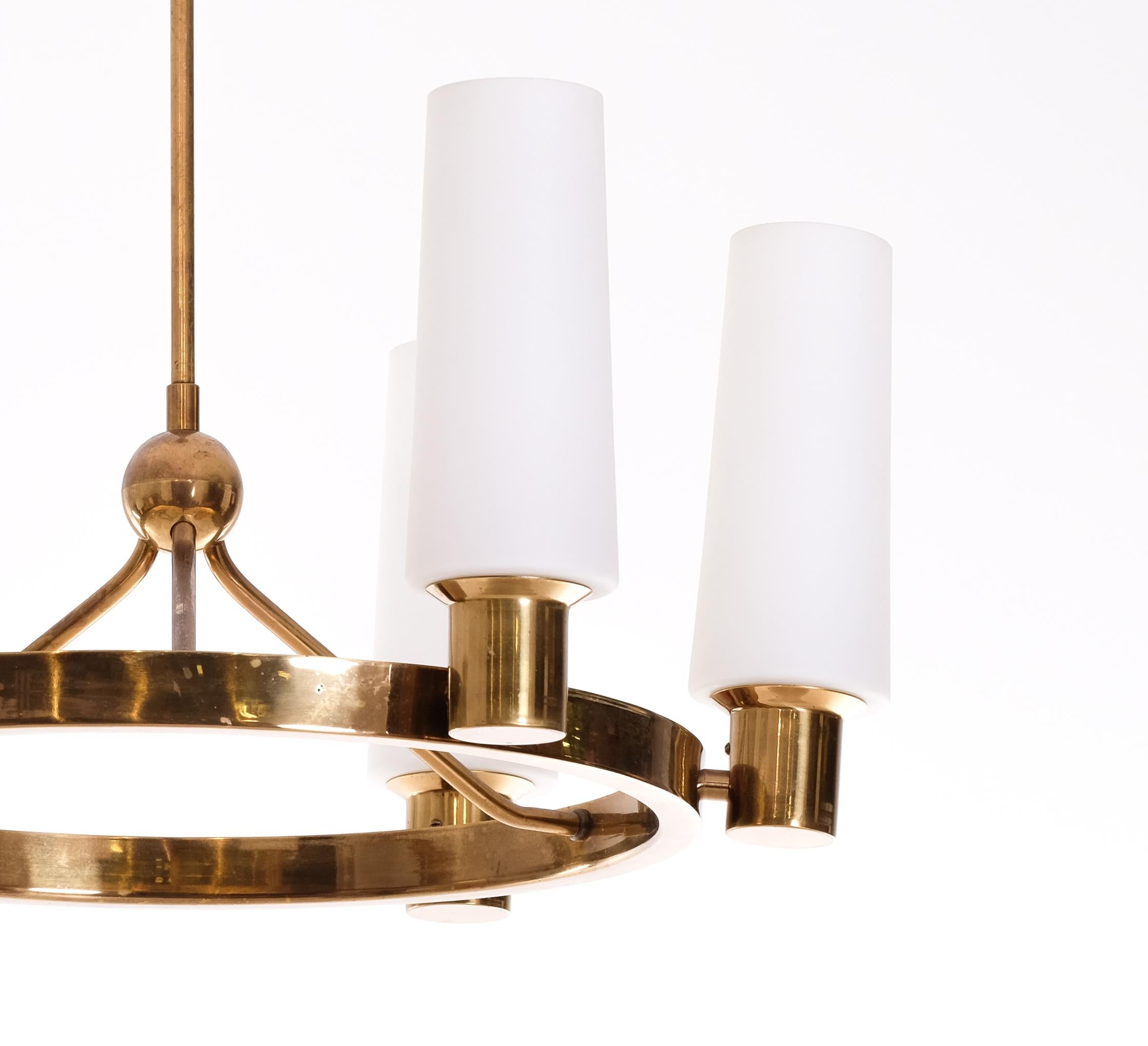 Rare set of 3 brass ceiling lights with opaline shades, produced by Böhlmarks, Sweden, 1950s.
The height is adjustable according to your preferences.  

Please note: Listed price is for one (1) chandelier. 

Measures: 
Height: 50 cm
Diameter: 58 cm.