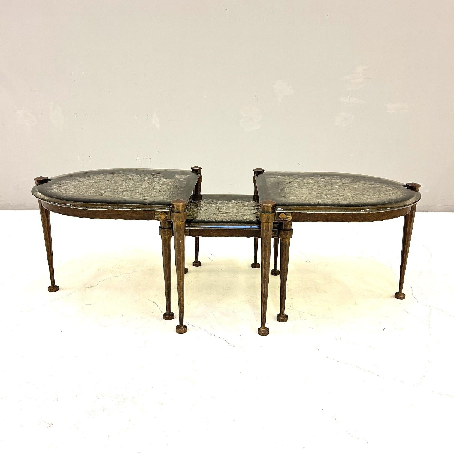 Set of three wrought iron tables.
Glass tops in cast smoked glass.
Designer, manufacturer, and country of origin unknown.