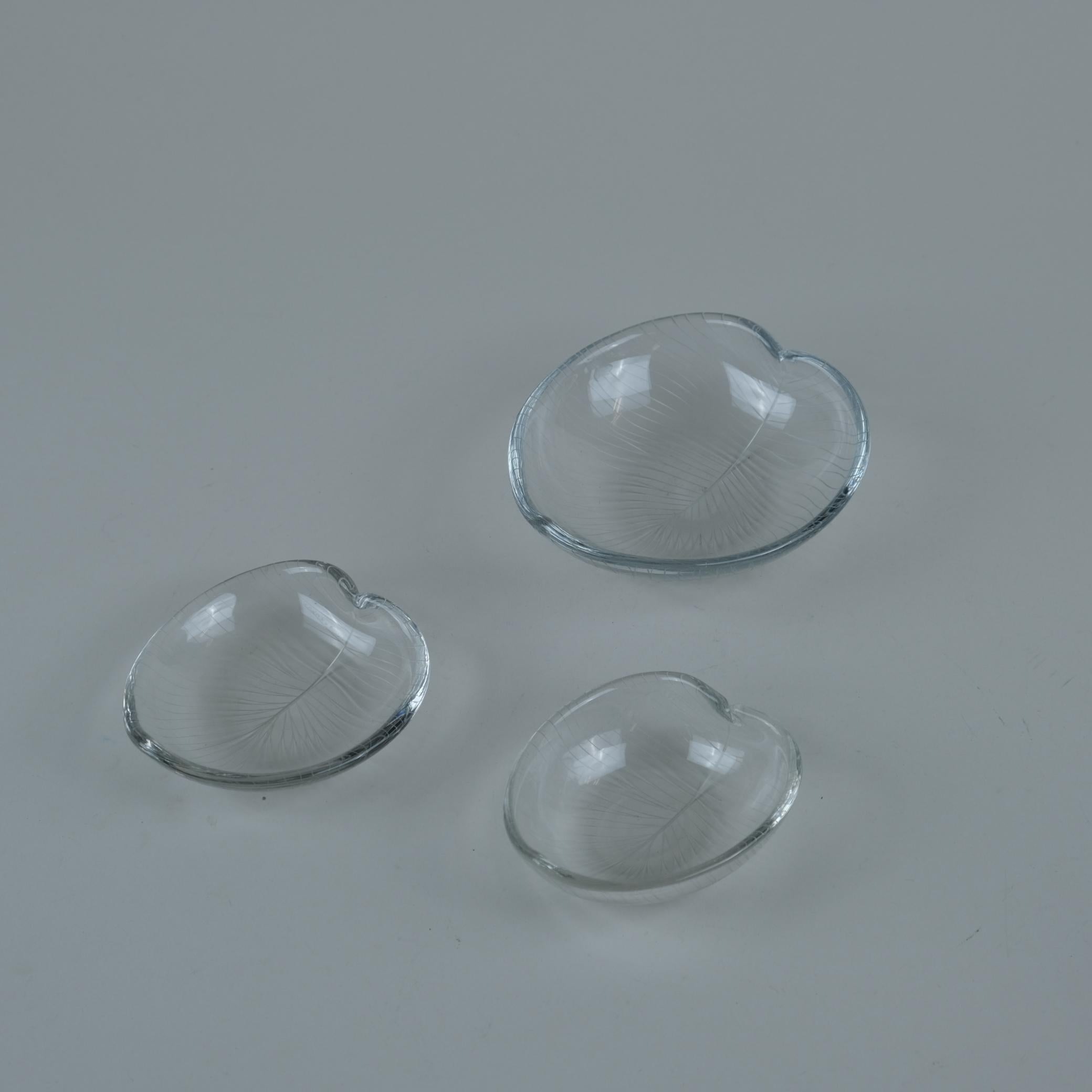 A set of three Tapio Wirkkala leaf art objects / vases for Iittala. The set is of three two different sized pieces from the line engraved series that is highly inspired by nature including leaves, flowers, seashell, mushrooms, animals, etc. The