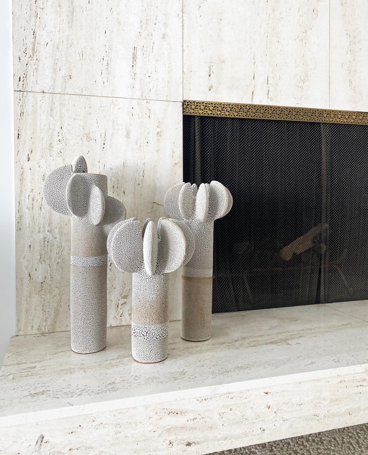 Set of 3 tempo sculptures by Olivia Cognet
Materials: Ceramic
Dimensions: 1 Tall around 55 cm tall 
 2 Medium 45 cm tall.
  

Tempo
Dynamic sculptures decorated with textured, subtly imperfect disks, in which repetition echoes the art of