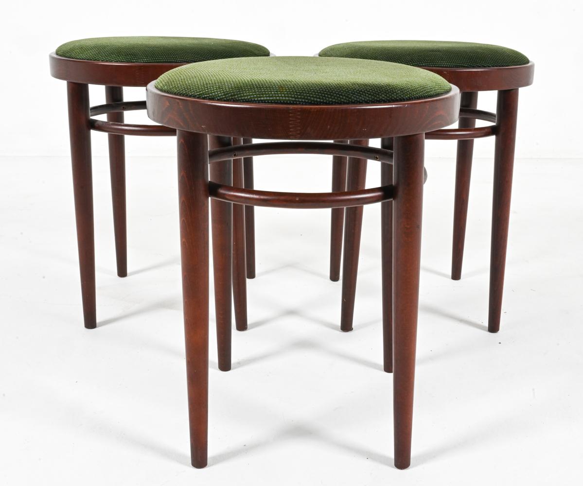Embrace the legacy of design with this stunning set of (3) Thonet model 214 PH stools. Designed by the Thonet brothers in 1880, the 214 PH stool embodies the elegance and innovation of Viennese design. Crafted from rich beech wood, these chairs
