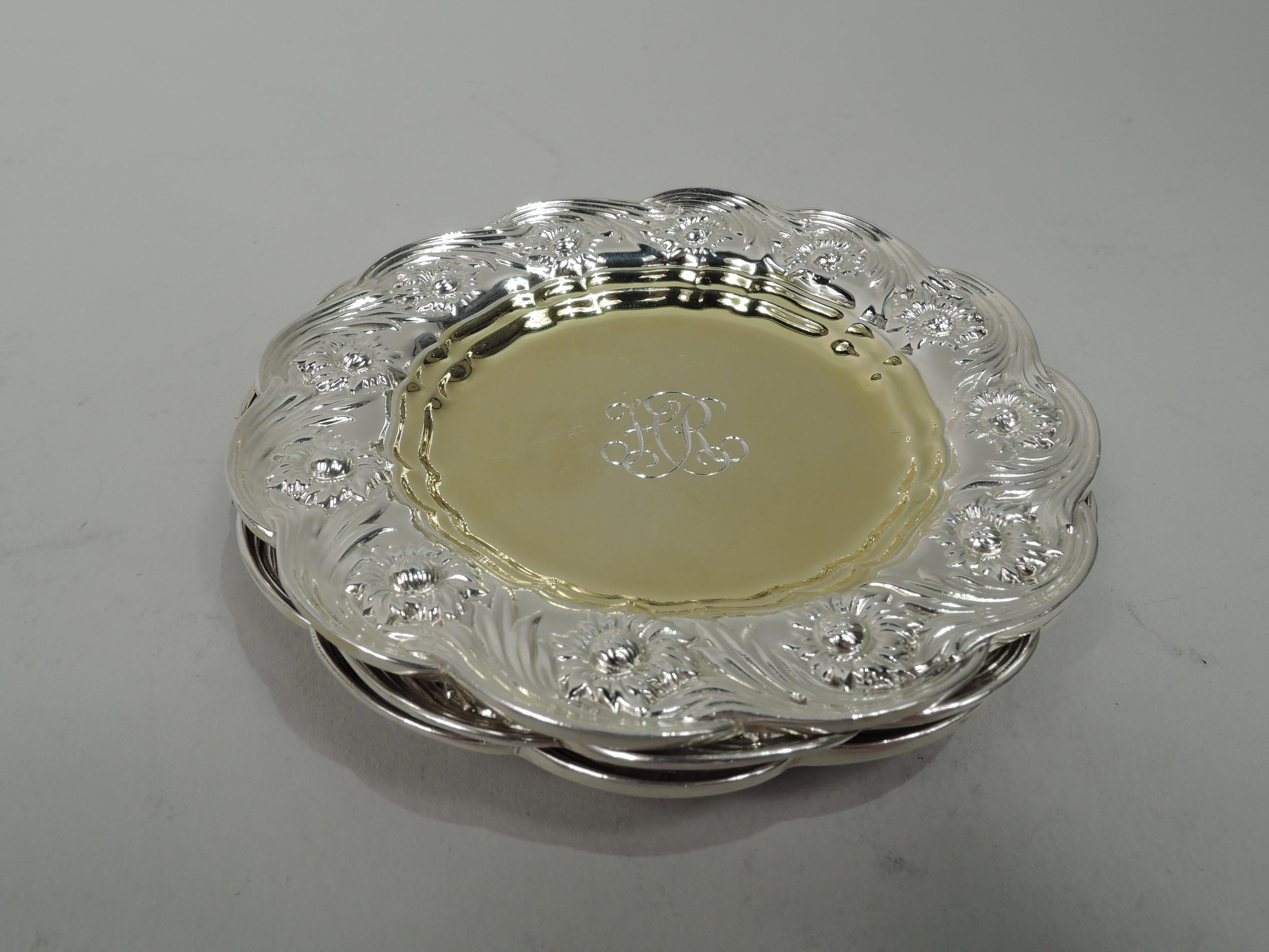 Set of 3 Chrysanthemum sterling silver butter pats. Made by Tiffany & Co. in New York. Plain and round gilt well. Shoulder has rinceaux-style flower heads and tendrils. Rim scalloped. Engraved interlaced script monogram. Marked “Tiffany & Co. /
