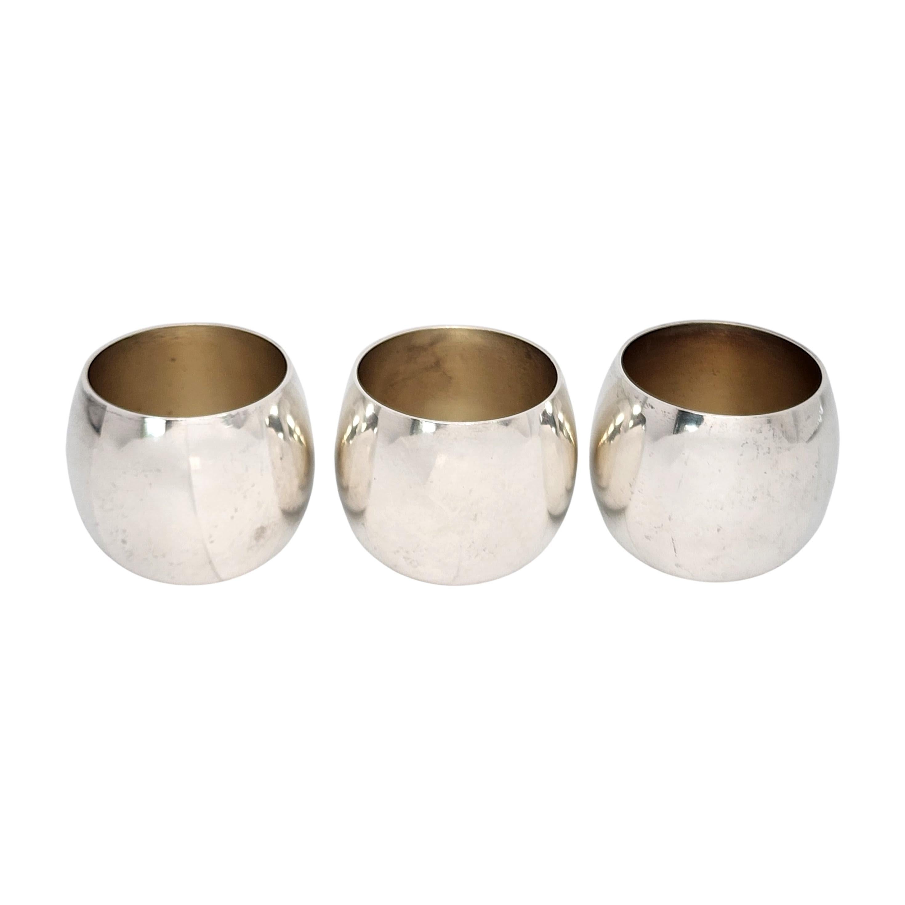 Set of 3 Tiffany & Co Makers sterling silver shot/cordial cups.

No monogram or engraving.

Round design with a smooth polished finish and a light gold wash interior. Does not include Tiffany & Co box or pouch.

Measures approx 1 3/8