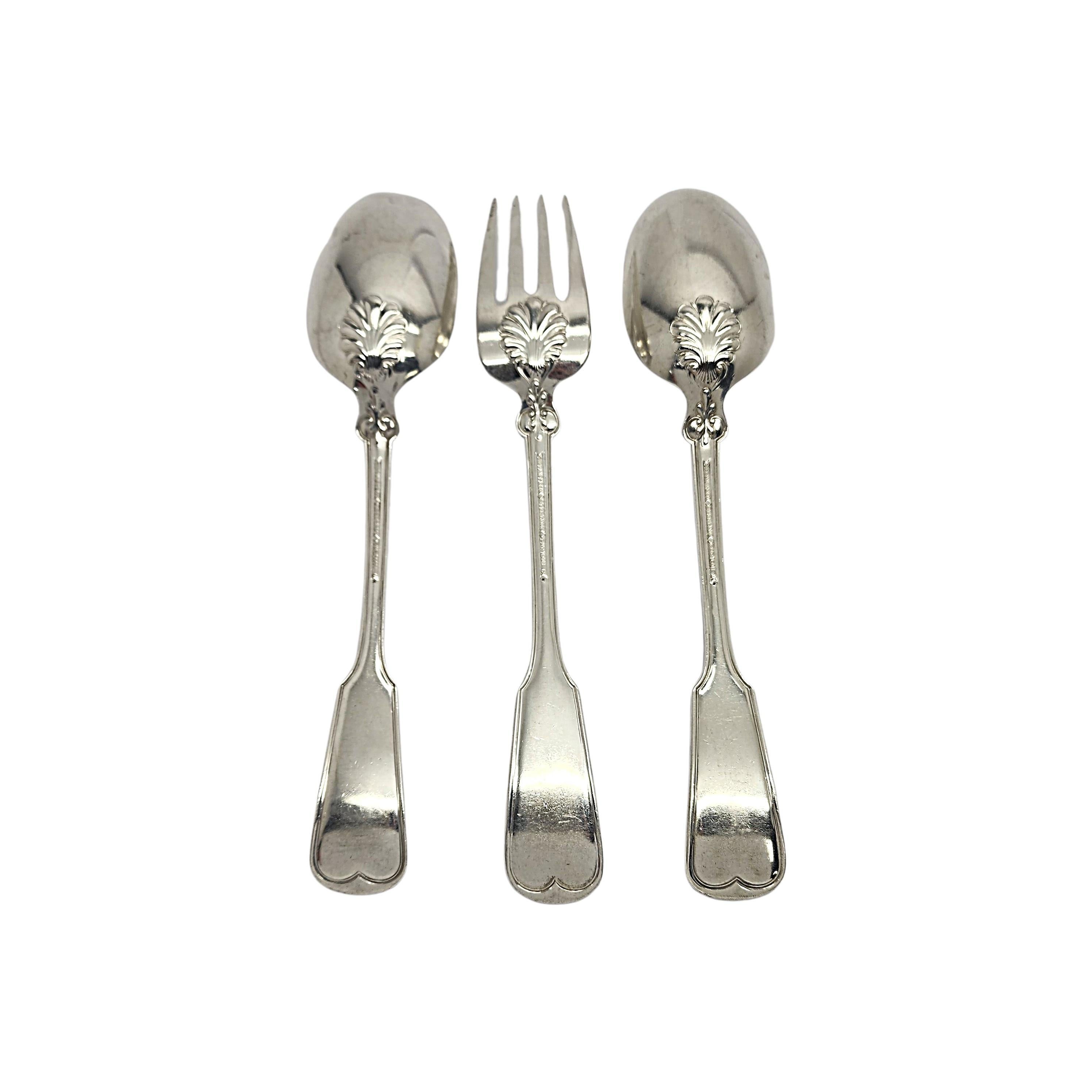 Set of 3 Tiffany & Co sterling silver serving spoons and fork in the Shell & Thread pattern by Tiffany & Co with monogram.

Monogram appears to be EWE

Two serving spoons and 1 serving fork in the Shell & Thread pattern which was introduced in 1905