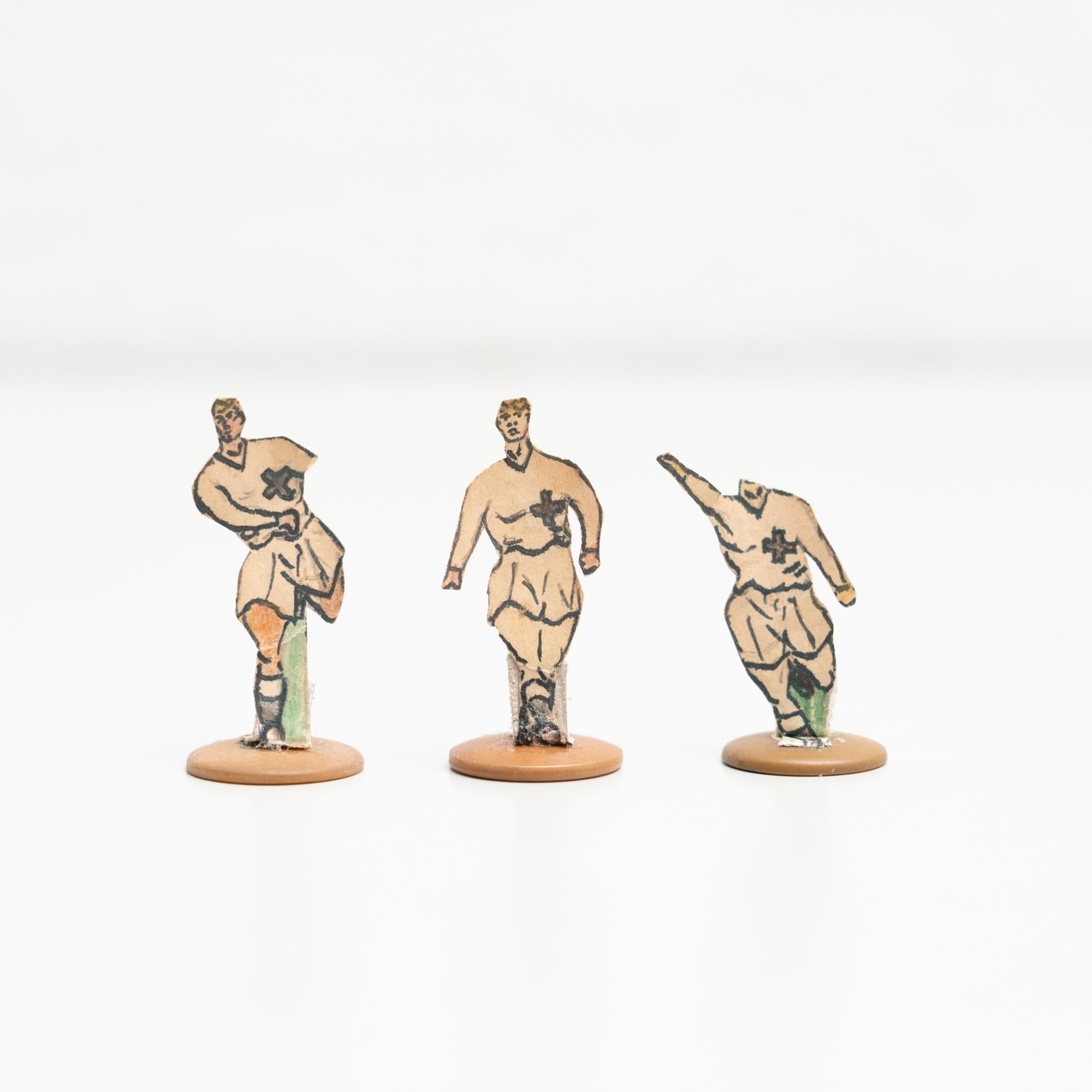 Set of three table button soccer game players. Traditional figures used to play this classic button Spanish game. 

The players are build buy attaching a printed photography or drawing of an actual football soccer player to a clothing button.