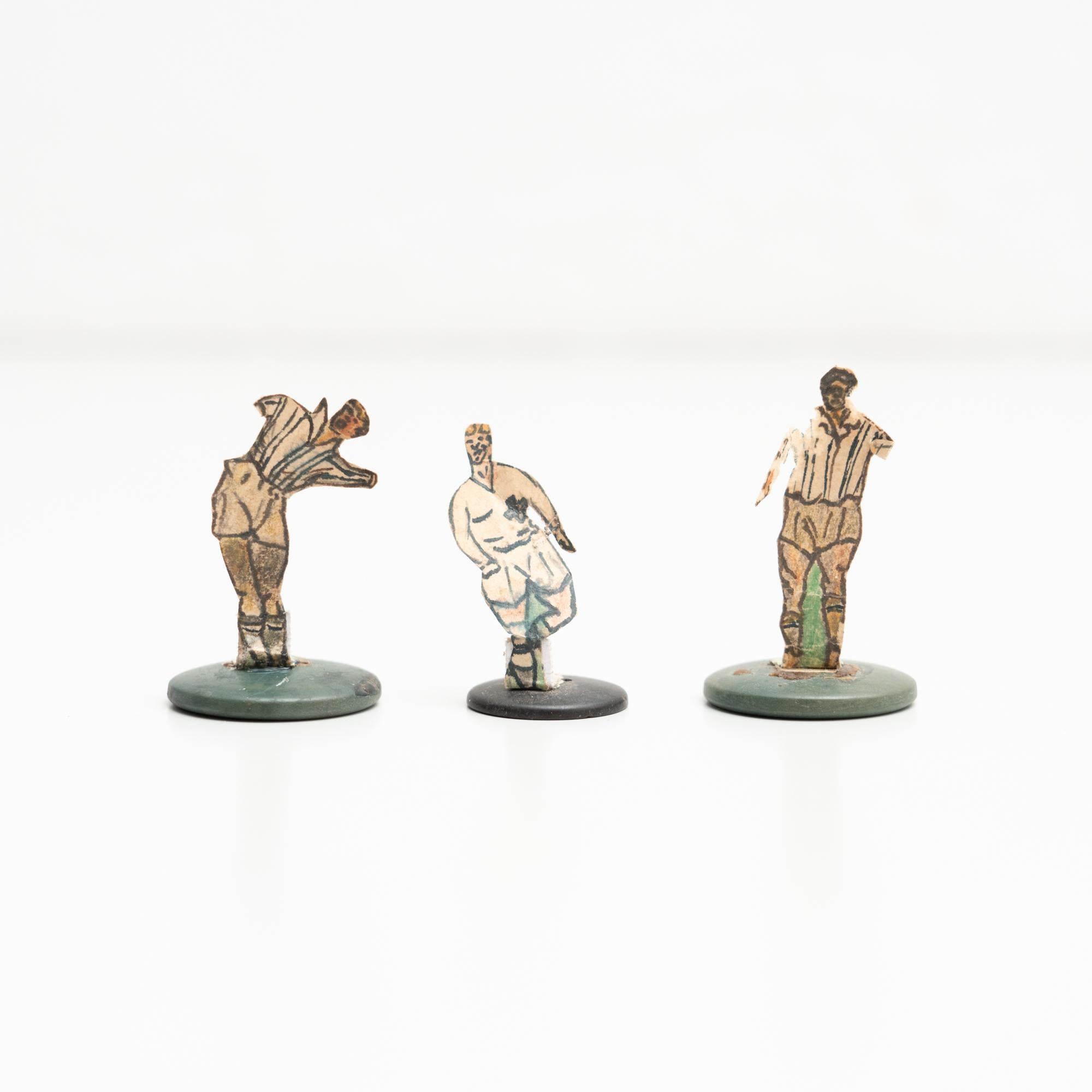 Set of three table button soccer game players. Traditional figures used to play this classic button Spanish game. 

The players are build buy attaching a printed photography or drawing of an actual football soccer player to a clothing button.