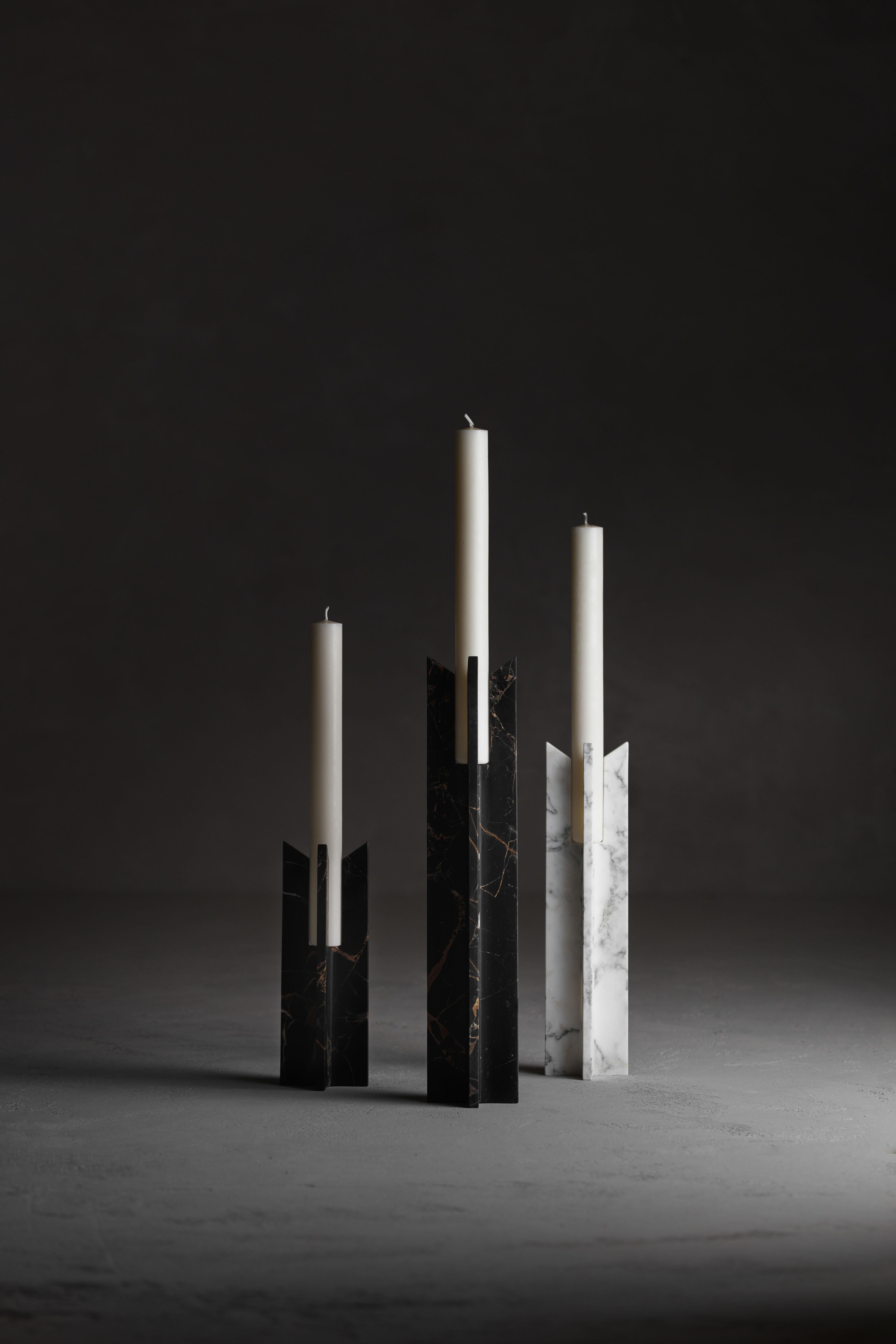 Set Of 3 Trinity Candlesticks by Kreoo 
Designed by Christophe Pillet
Dimensions: Small: Ø 10,5 x H 30 cm.
Medium: Ø 10,5 x H 42 cm.
Large: Ø 10,5 x H 53 cm.
Materials: Calacatta Carrara and Black and gold marbles.

Available in different marble