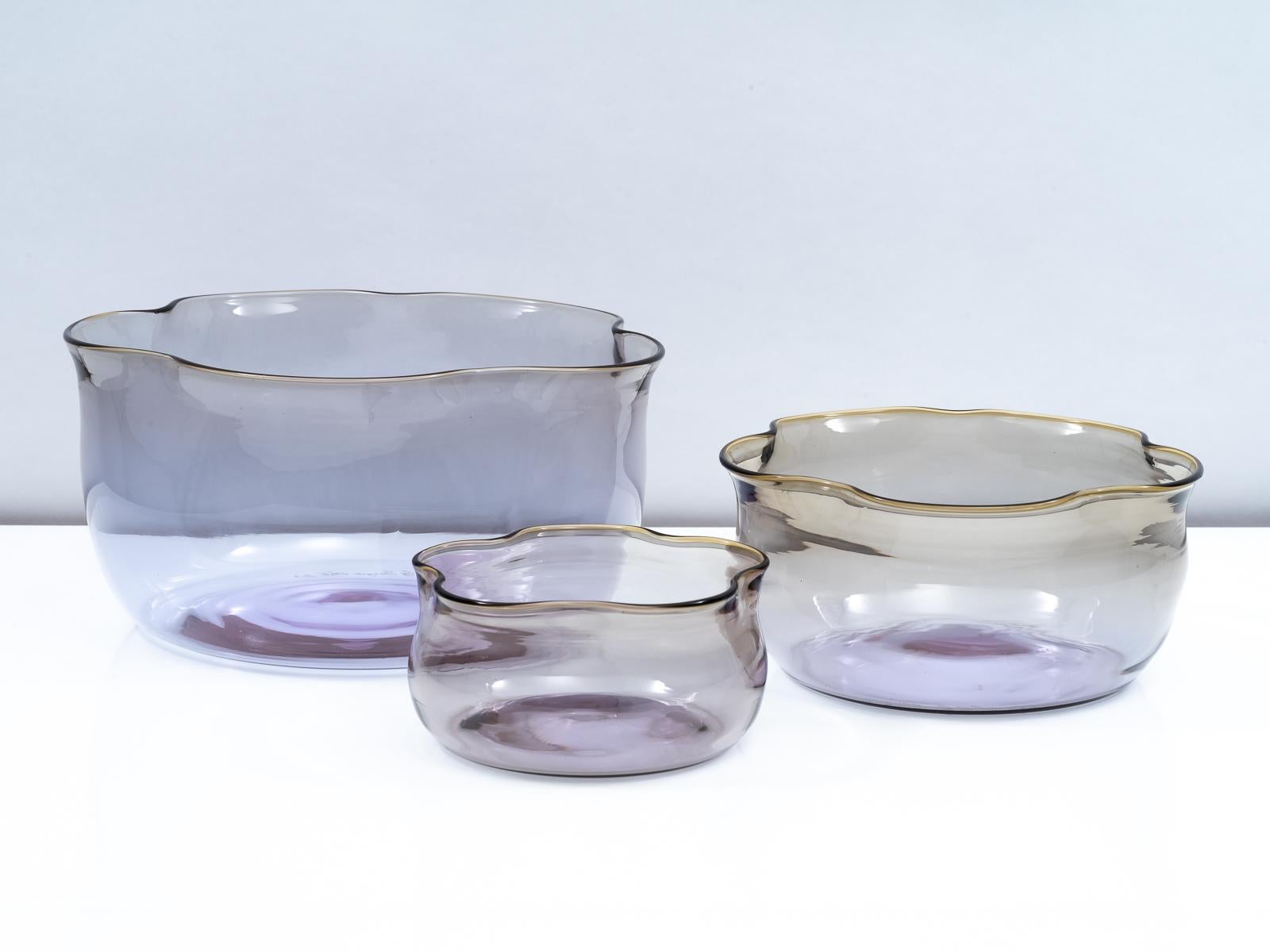 Stunning set of three blown glass nesting vases designed by Sergio Asti for Salviati in 2003. Each vase has a light purple alexandrite base that delicately transitions to grey ochre at the upper rim. Can be nested for a unique effect or displayed