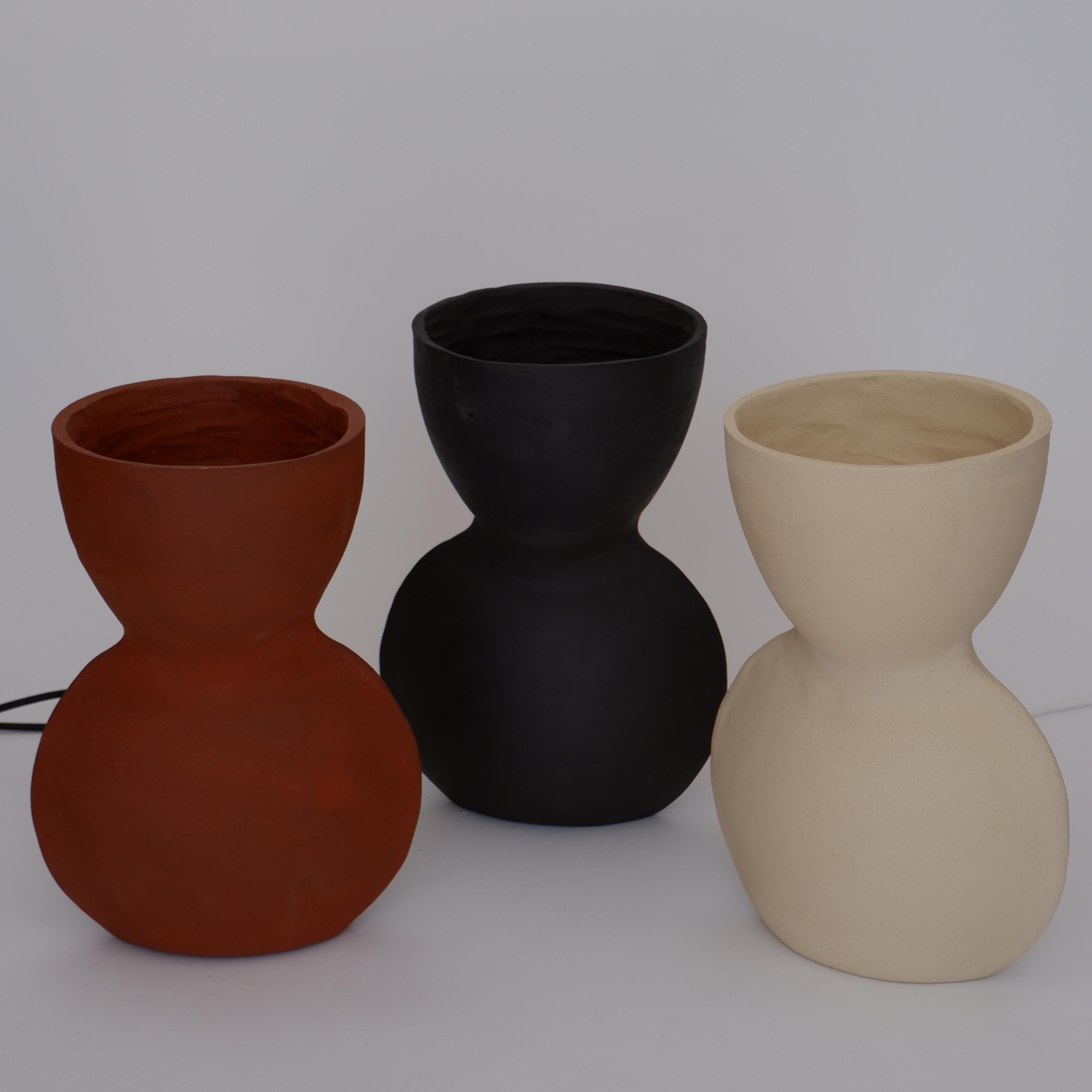 Set Of 3 Unira Big Lamps by Ia Kutateladze
One Of A Kind.
Dimensions: D 17 x W 23 x H 32 cm.
Materials: Clay.

Each piece is one of a kind, due to its free hand-building process. Different color variations available: raw black clay, raw white clay