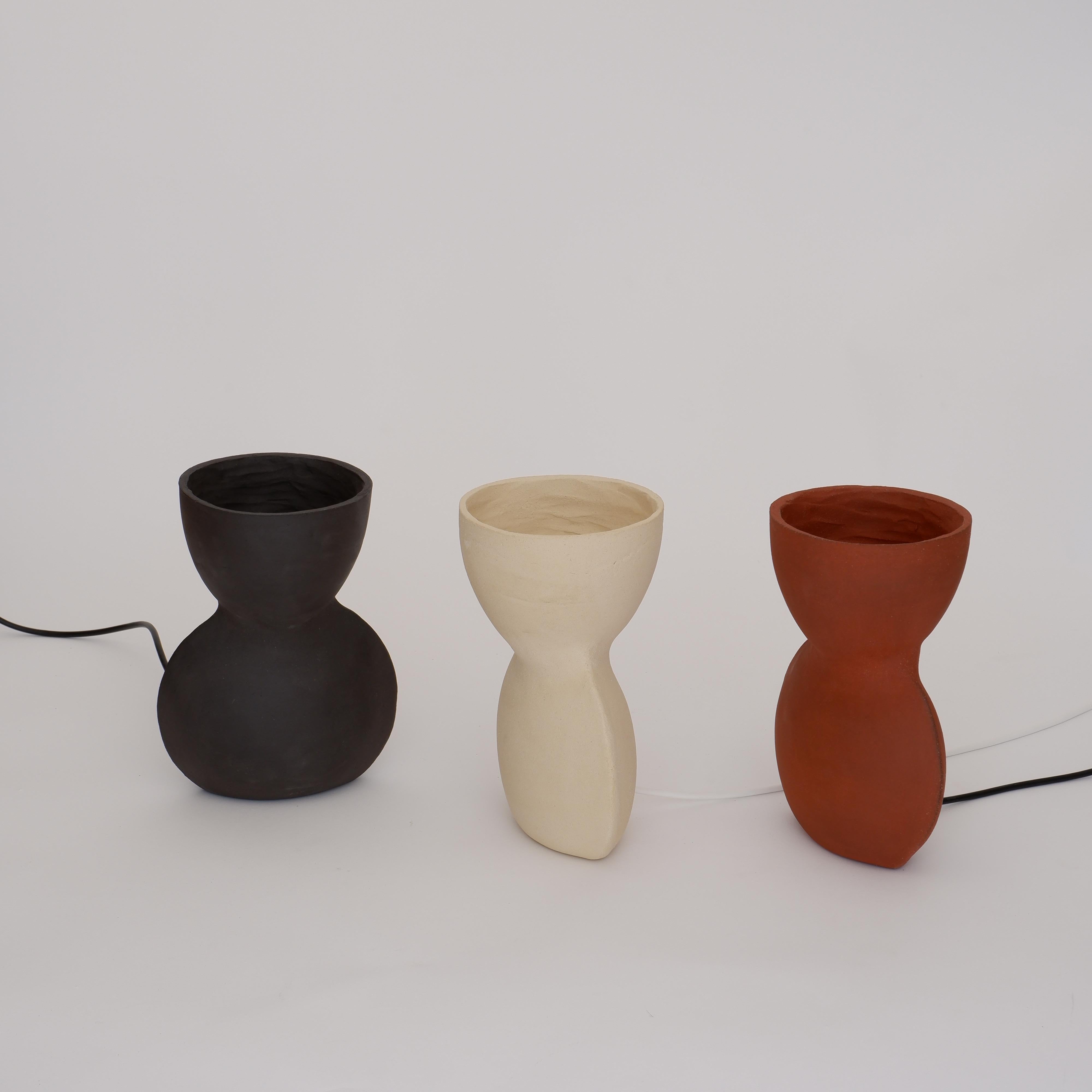 Set Of 3 Unira Small Lamps by Ia Kutateladze
One Of A Kind.
Dimensions: D 14 x W 18 x H 25 cm.
Materials: Clay.

Each piece is one of a kind, due to its free hand-building process. Different color variations available: raw black clay, raw white clay