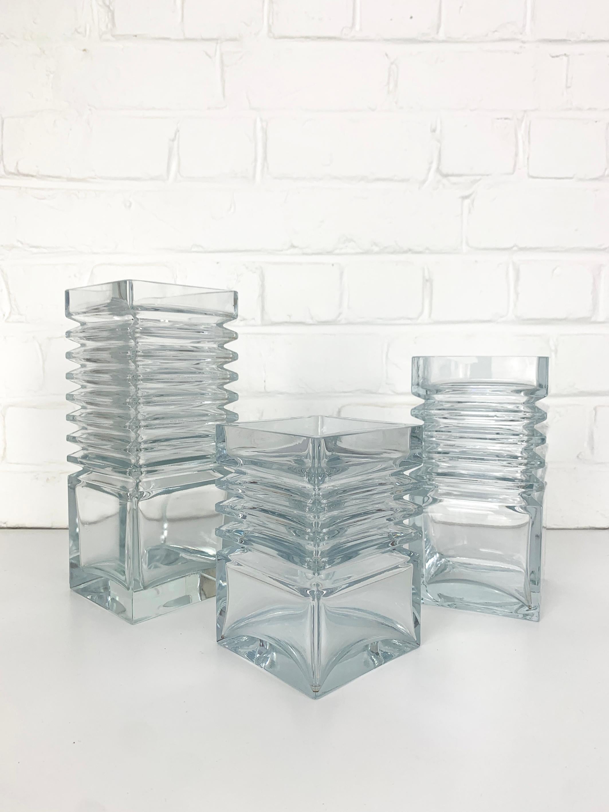 Set of 3 clear glass vases designed by Tamara Aladin. 

They are part of the Hamonikka series, one of the most simple but striking series created by the finnish designer in the 1970s.

Manufactured by Riihimaen Lasi Oy. 

The size of the vases is