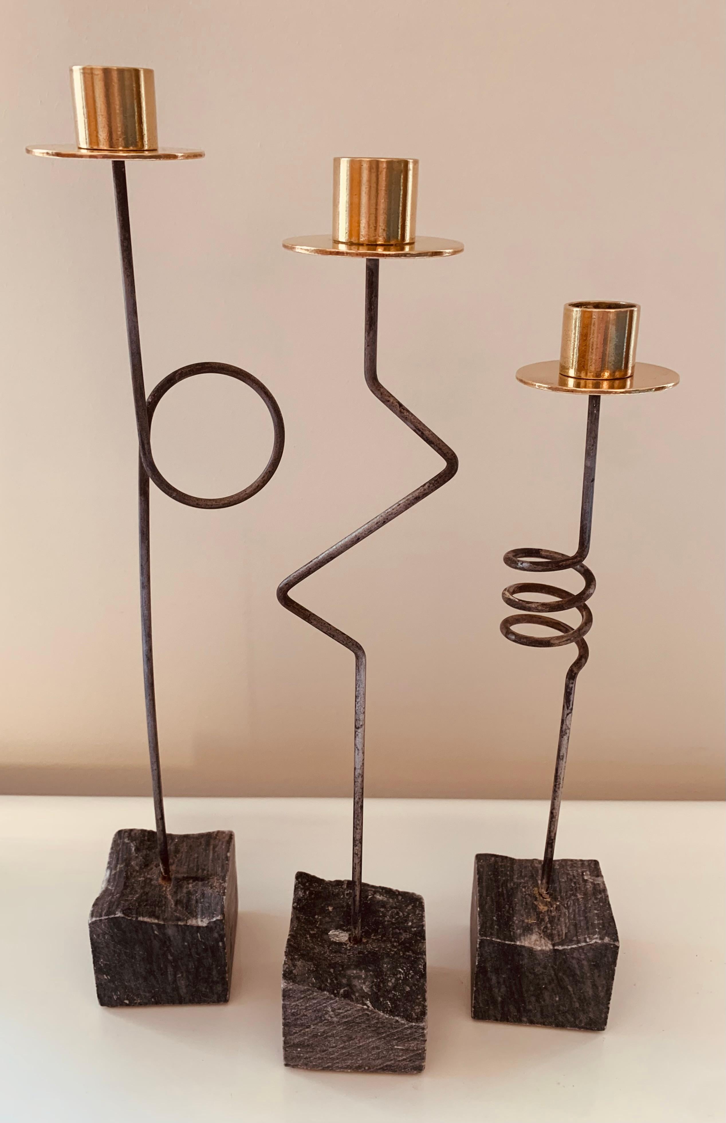 An unusual set of 3 vintage Ikea 1980s Kräsen candle holders designed by Ehlén Johansson. The three candle holders form an abstract Picassoesque face with an eye, nose and corkscrew mouth. Each one is constructed with a brass candle holder and wax