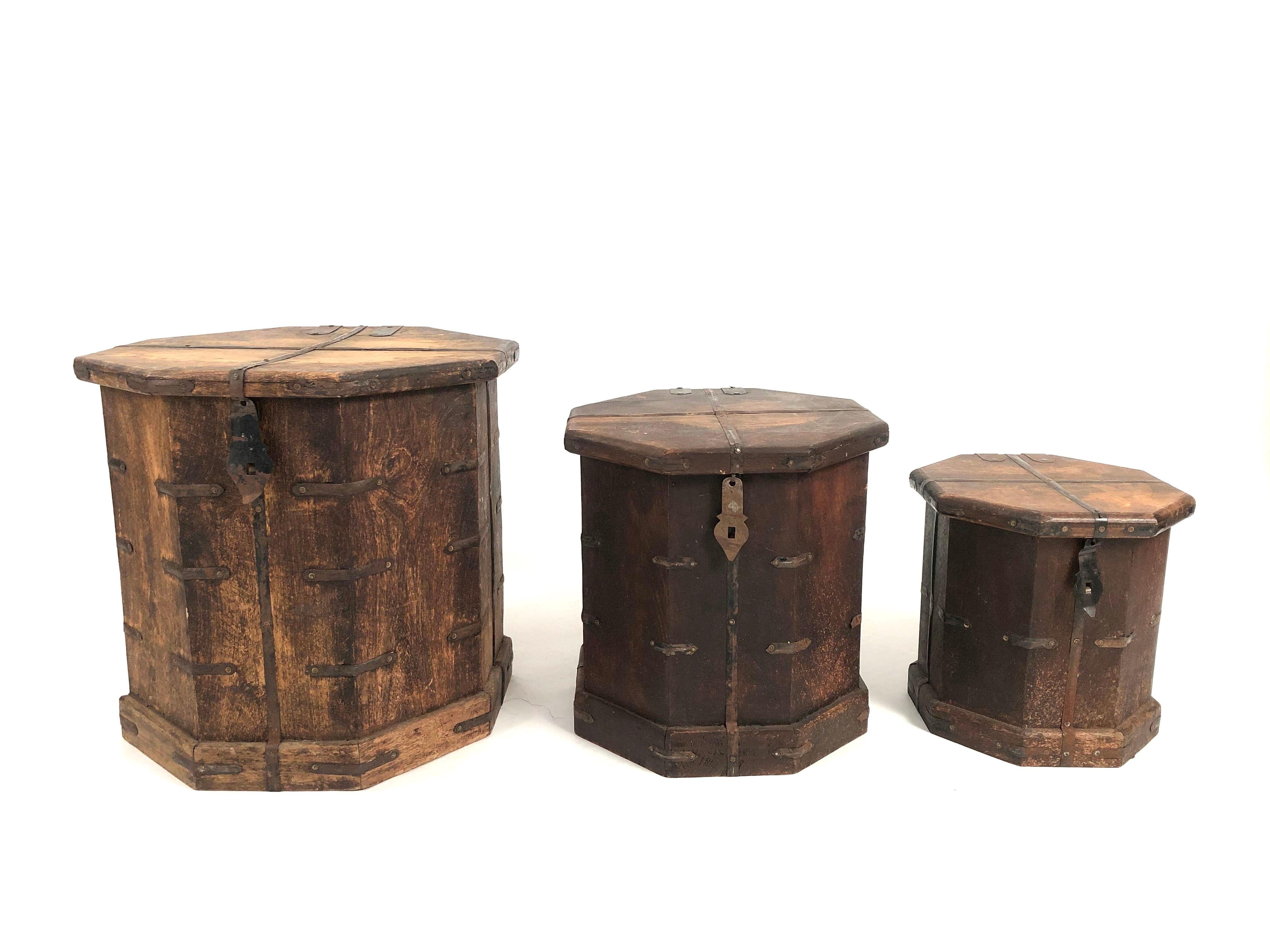 A set of 3 vintage Asian octagonal hardwood nesting boxes with metal strapwork which work beautifully individually or as a group of occasional tables, providing handy storage inside of each. The 3 tables nest comfortably, one inside the other.