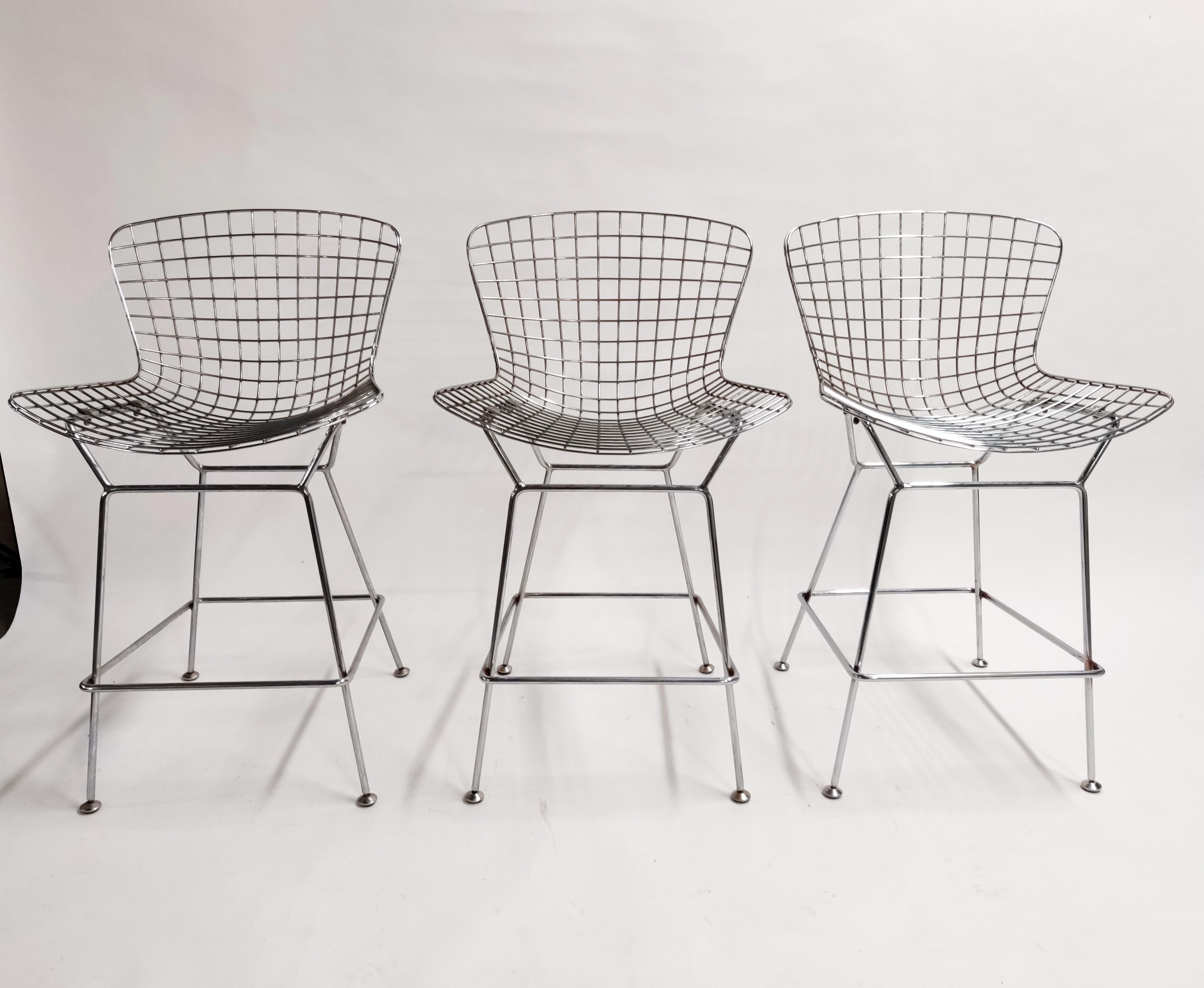 Set of 3 chrome wire bar stools in the style of Bertoia.

These are vintage examples with a lovely patina.

They come with the original leather seat pads.

Beautiful timeless design.

A few design features tell us this aren't knoll