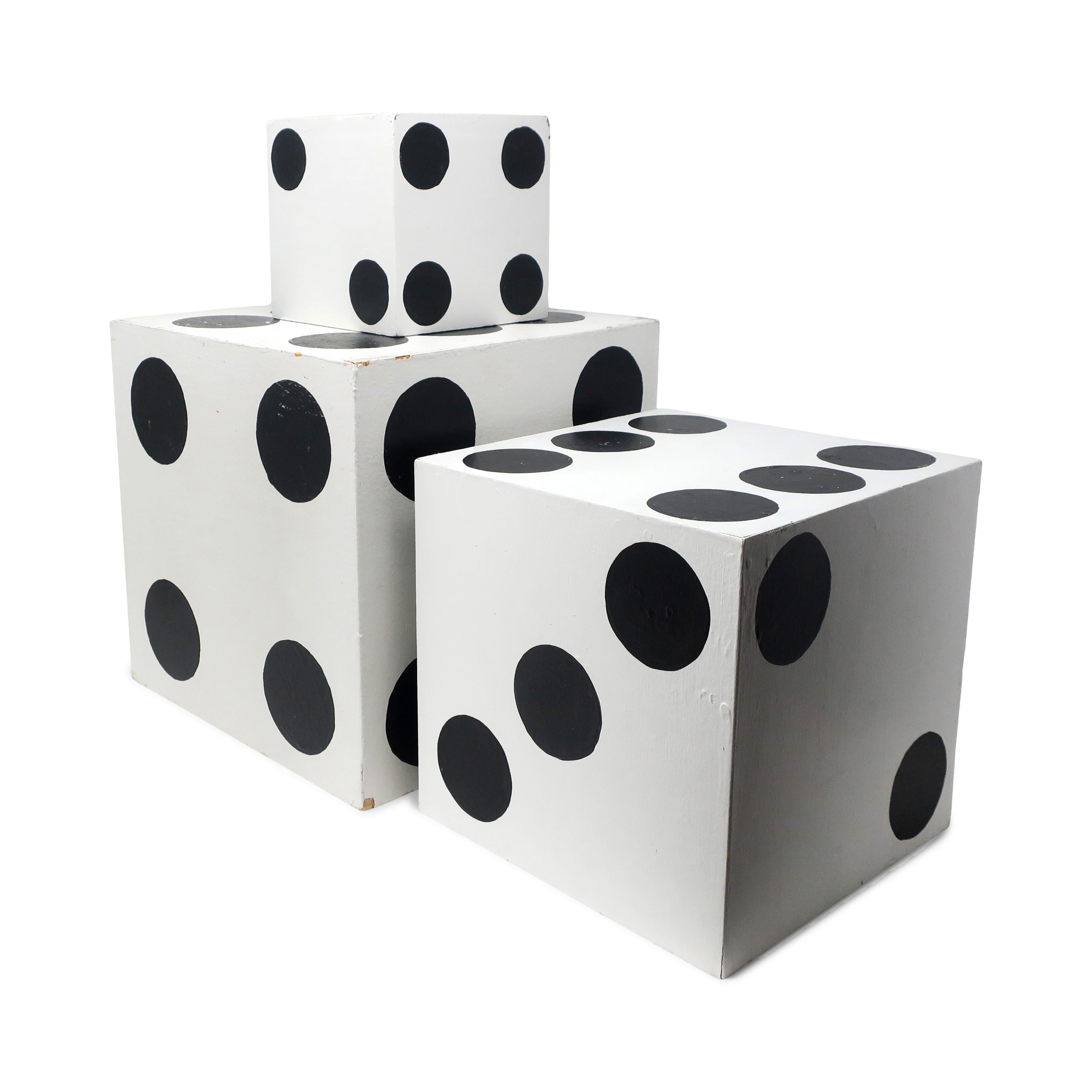 A set of three giant dice. Handmade, hand painted, and designed with one open side to nest inside of each other. Perfect on a table or shelf as decorative objects or for use as bookends.

In good vintage condition with wear consistent with age.