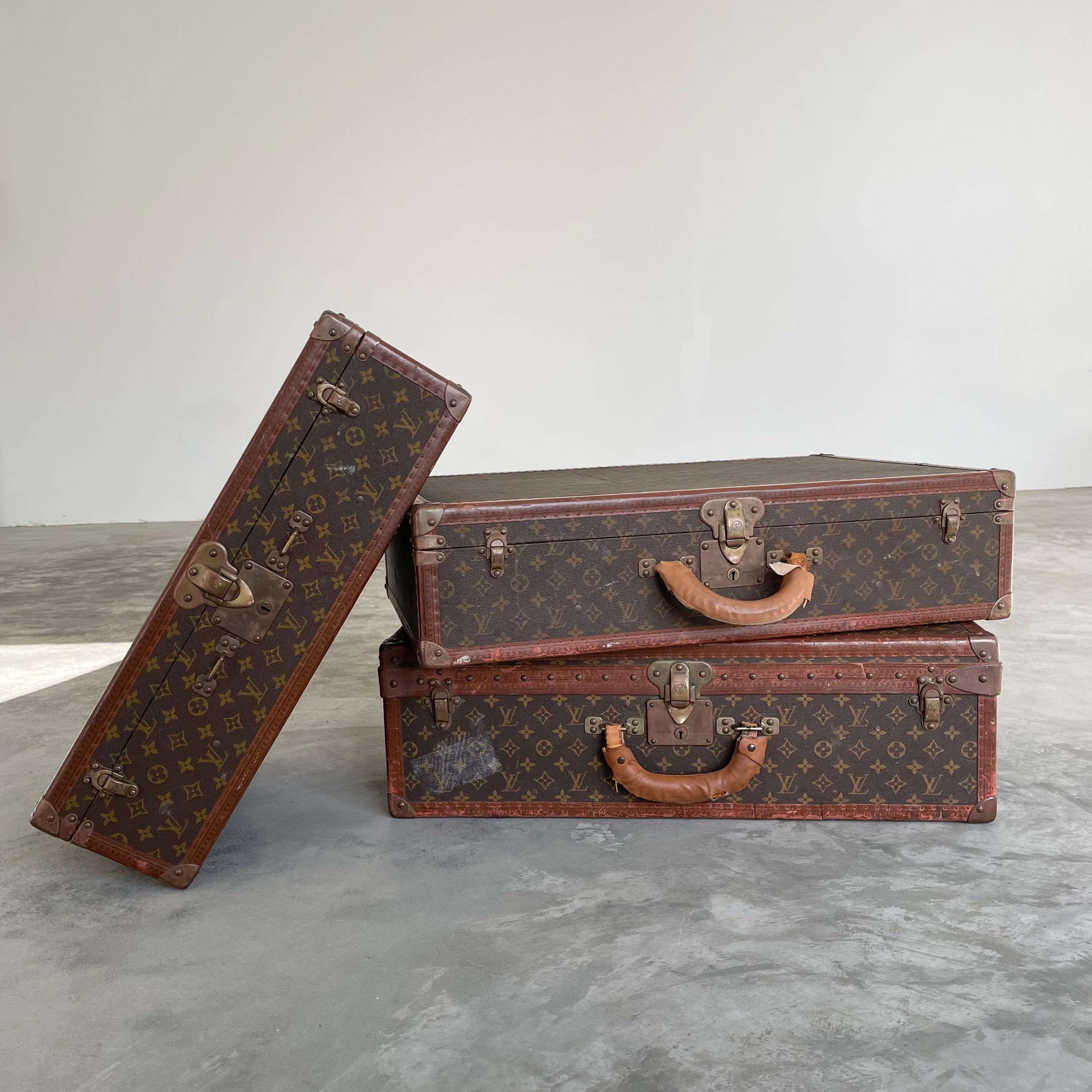 Set of 3 classic vintage Louis Vuitton trunk suitcases from 1948. Perfect as art displayed in the home and functional for travel and weekend trips. These LV monogram print trunks are made with saddle leather and brass hardware and wrapped in the