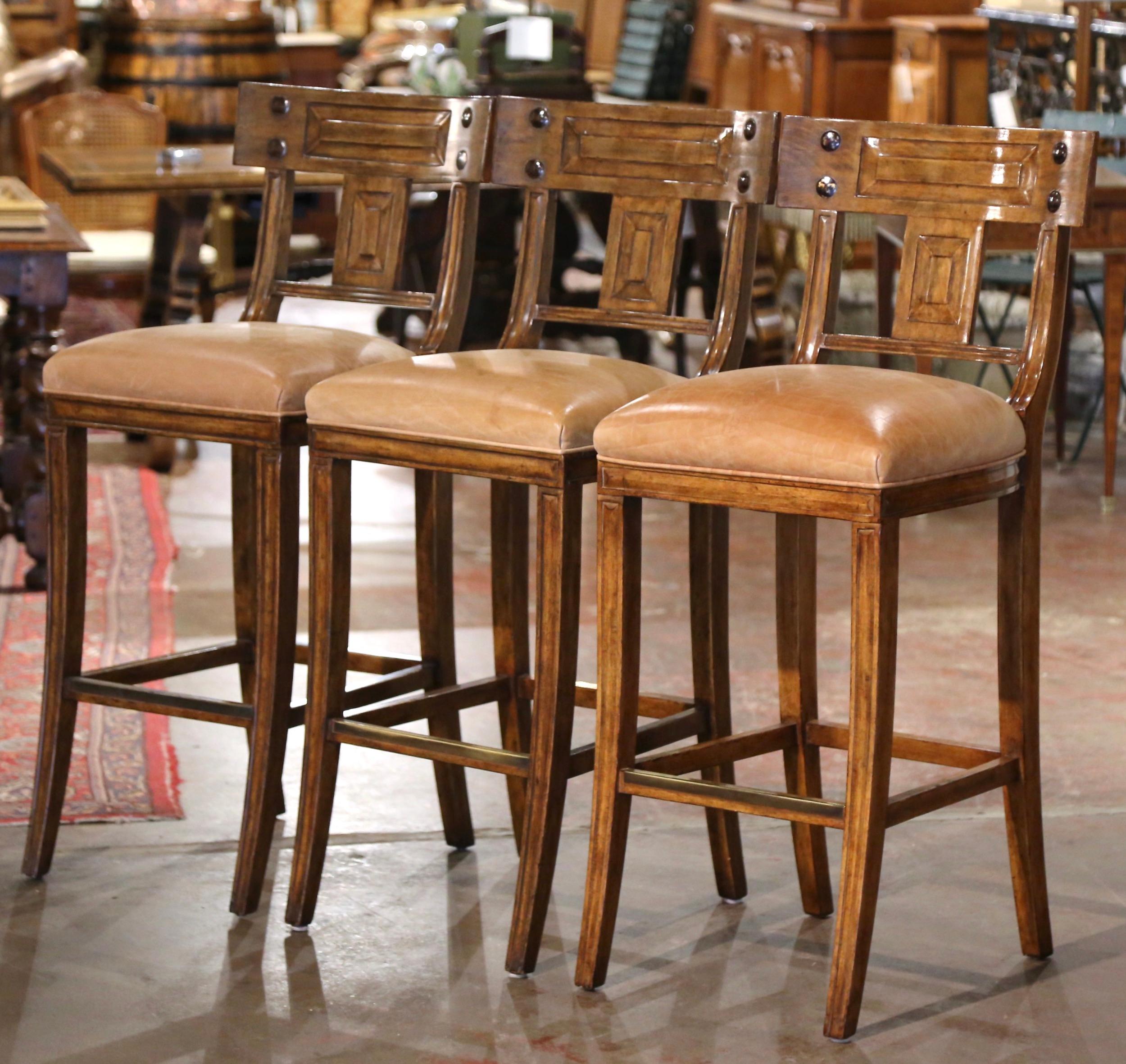 Place these large three stools with back around a kitchen island for extra seating. Crafted by Michael Taylor Designs circa 2000, the Classic bar stools are 30.5” in seat height, the perfect height for a tall bar! Each curved back decorated with