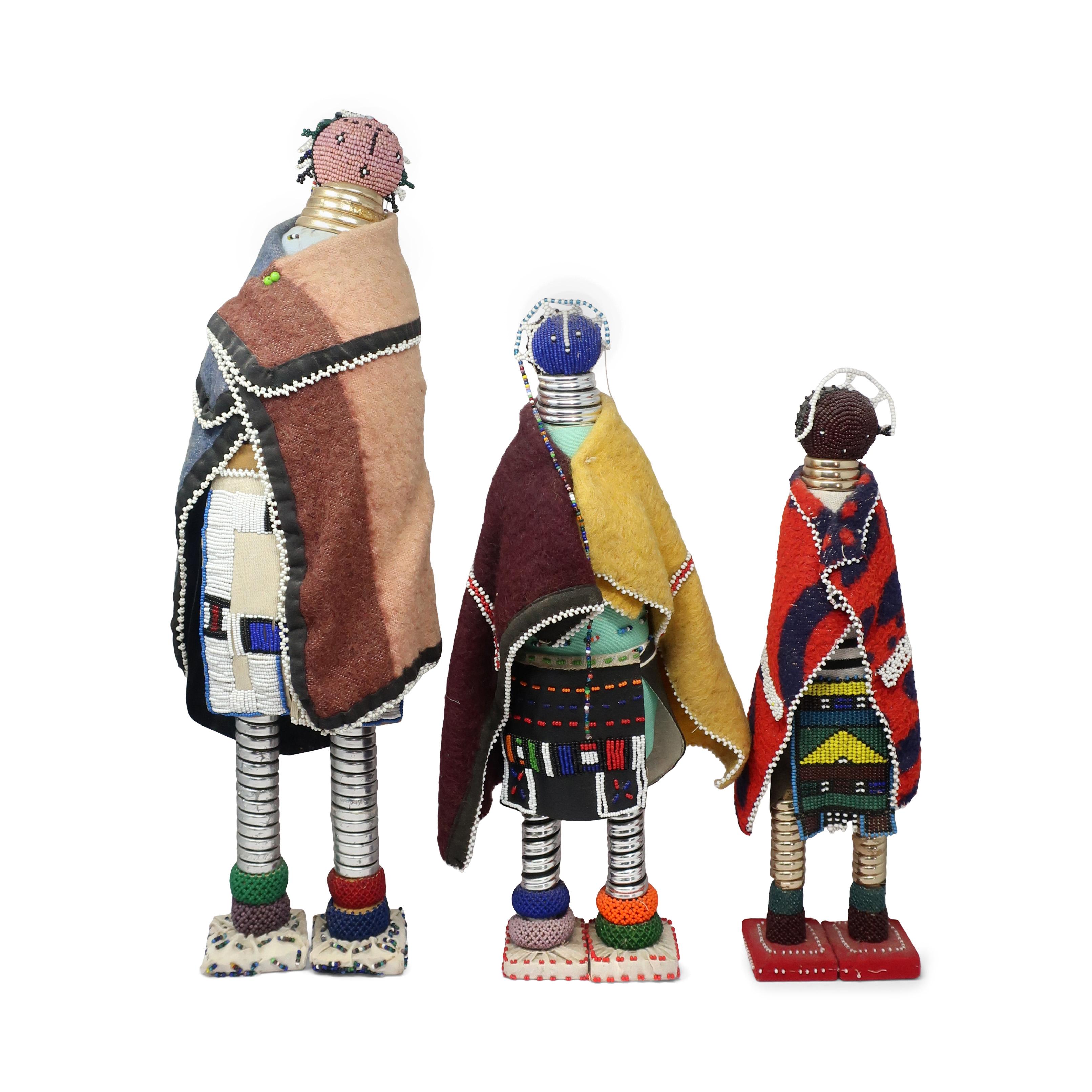 Traditionally made by Ndebele, Zulu and other southern African tribes,  these beautiful beaded dolls are used to encourage fertility and instruct girls at time of their initiation into womanhood.  A set of three.  In good vintage condition with wear