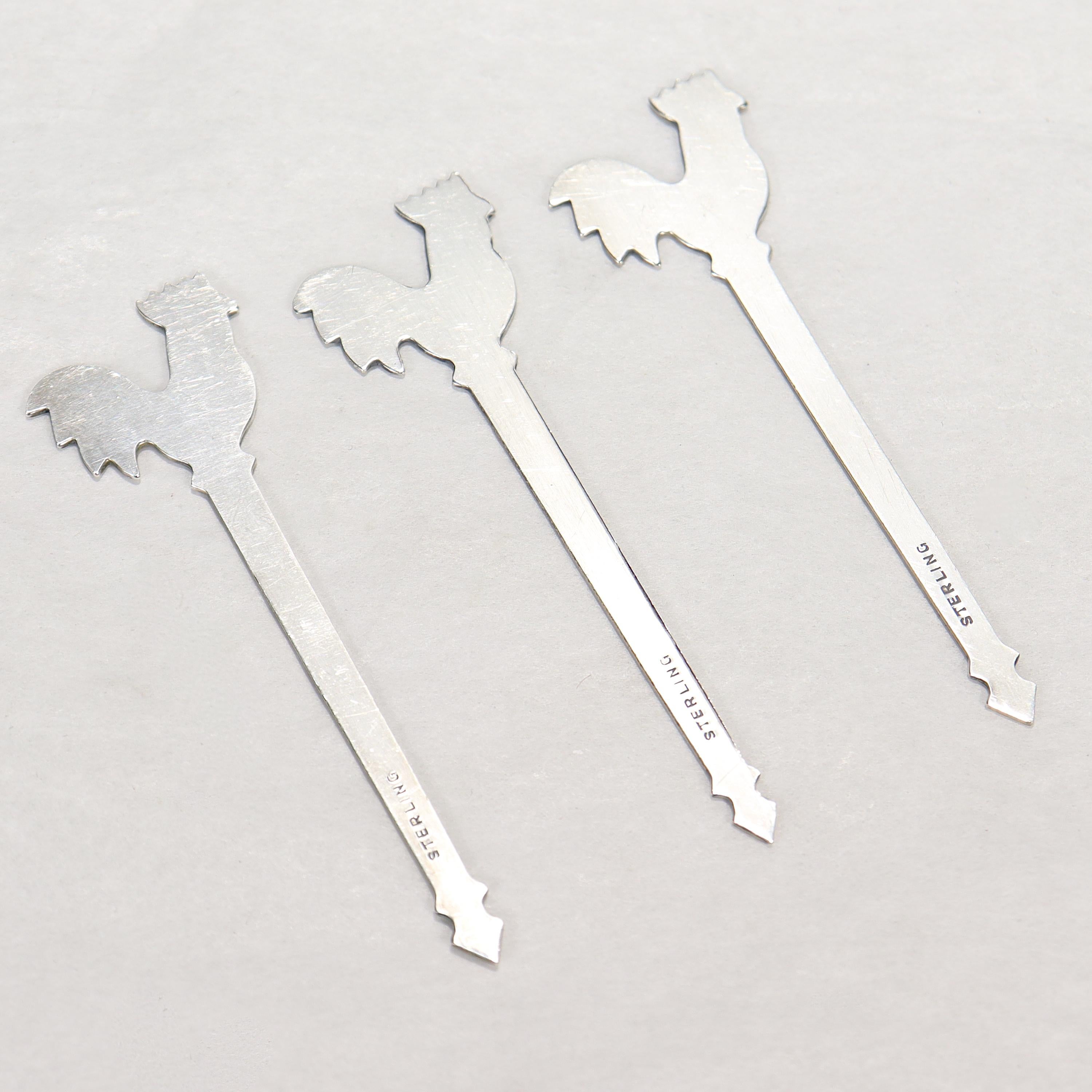 A fine set of 3 vintage martini or cocktail picks.

In sterling silver. 

With rooster finials. 

Simply great bar accessories!

Date:
Mid-20th Century

Overall Condition:
They are in overall good, as-pictured, used estate condition with some fine &
