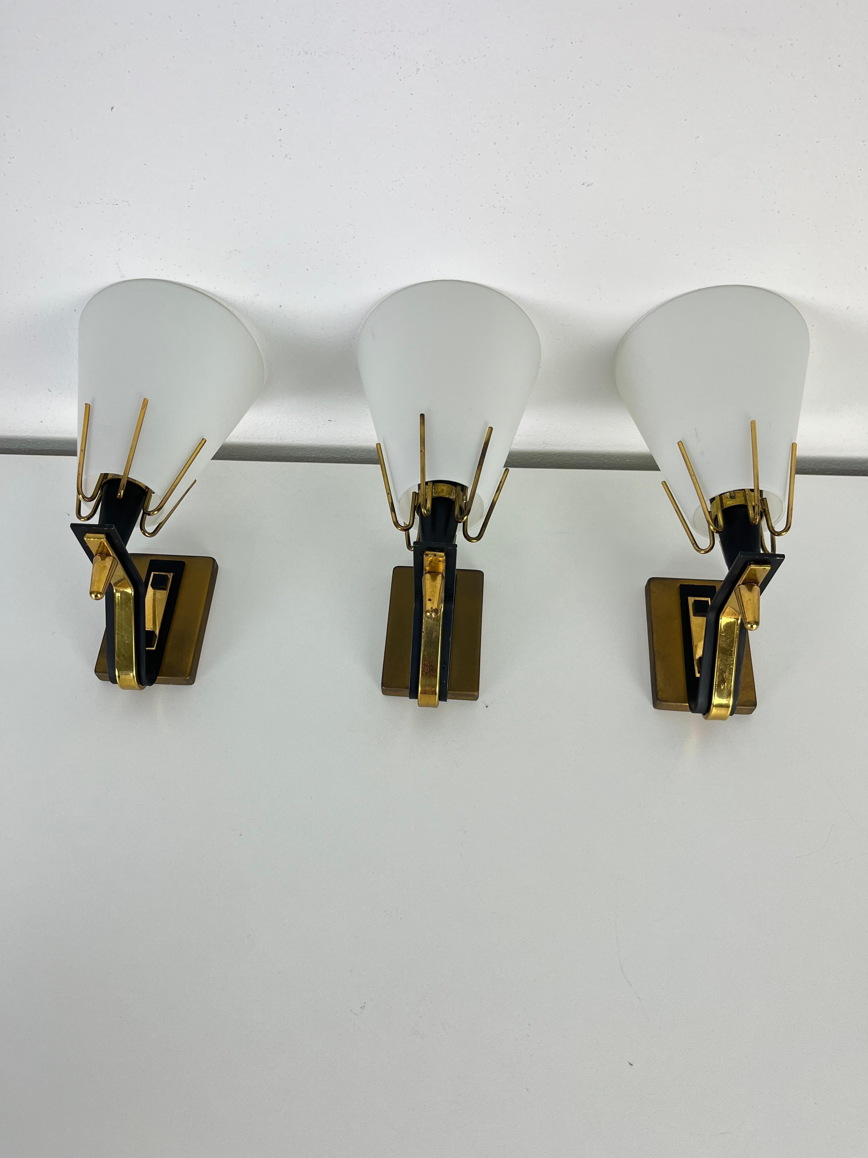 Set of three metal, brass, and opaline glass wall lamps attributed to Stilnovo, 1950s
Glass intact, E14 lamps.
Good condition.
Found in a noble apartment in my hometown, Palermo.

Another set of two is available online.

We guarantee prompt shipping