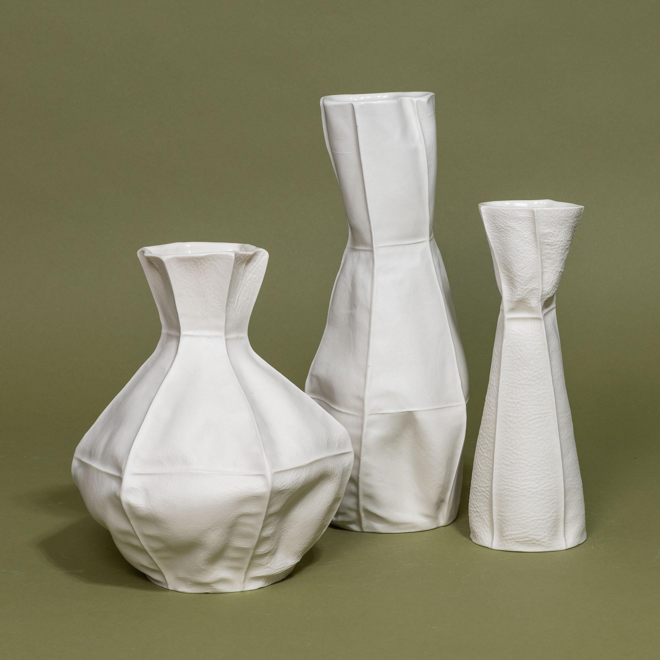 A set of three white ceramic Kawa Vases by Luft Tanaka Studio. Each item is made by casting porcelain into sewn leather molds and are truly one-of-a-kind.

As a result of the production process, each item is one-of-a-kind. Set includes three vases