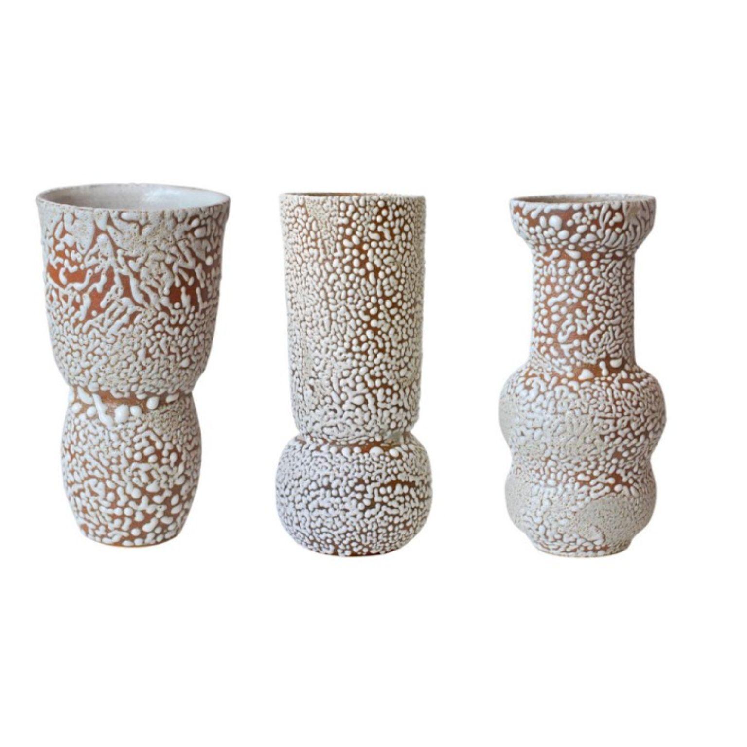 Set of 3 white stoneware vases C-019, C0-15, C-018 by Moïo Studio
Dimensions: D14 x W14 x H30 cm
Materials: White crawl glaze on tan stoneware
Made by hand on the wheel
Unique piece, consult for multiples

Is the Berlin-based ceramic art