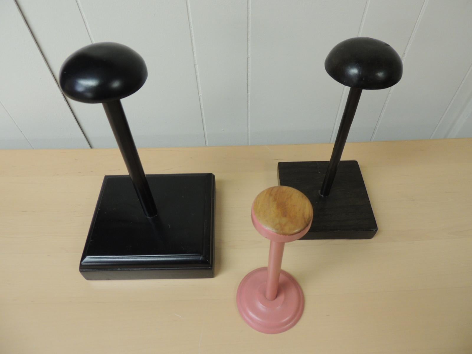 Set of (3) wood hat stands.
One brow, one black and one pink.
Large blk: 8 x 8 x 13 H
Med. brown: 6 x 6 x 12 H
Small pink: 4 x 4 x 9.5 H.