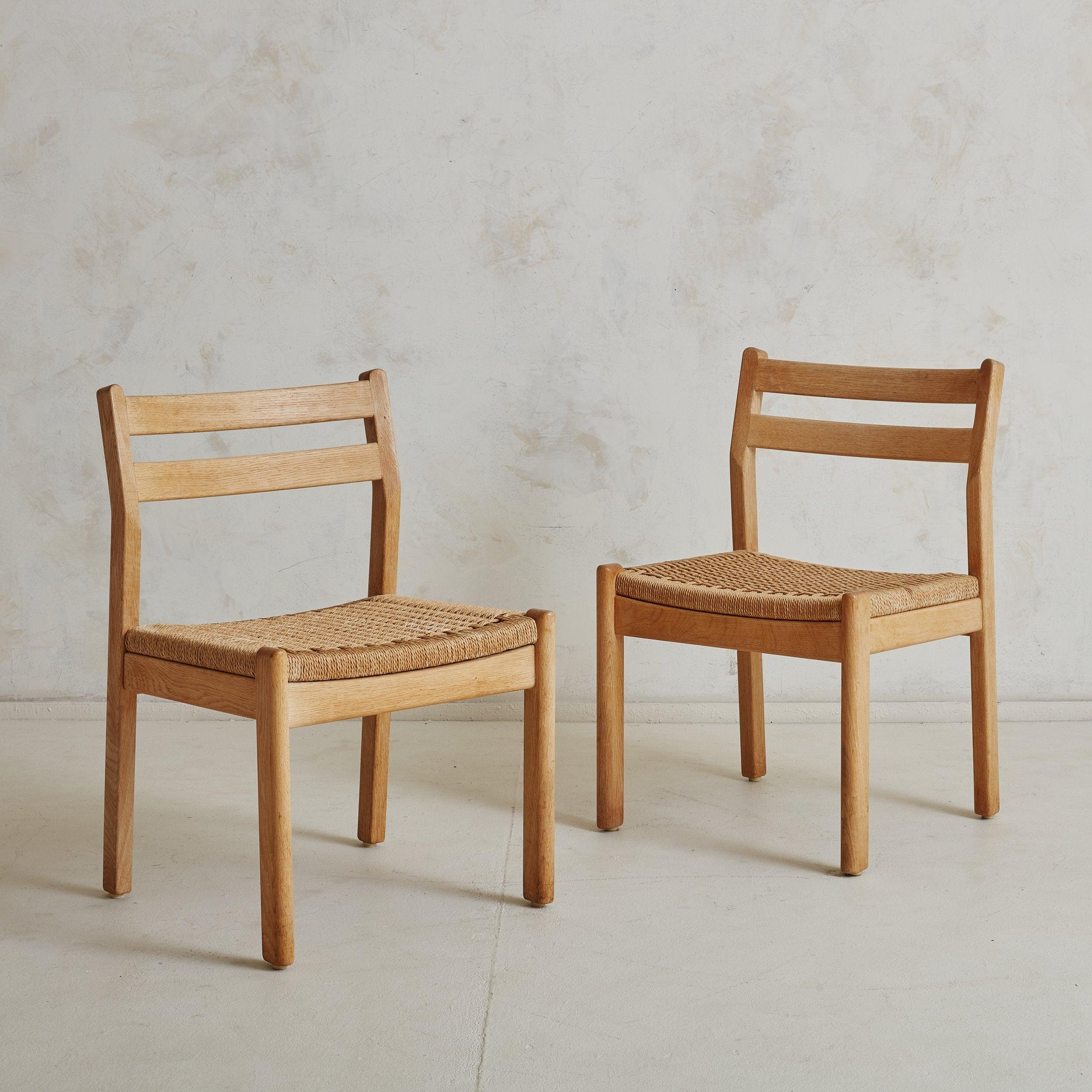 Set of 3 Danish wood and woven papercord dining chairs designed by Kurt Østervig in the 1960s. These Scandinavian Modern dining chairs feature minimalistic frames composed of stunning blonde wood and intricately woven papercord seats. The tightly
