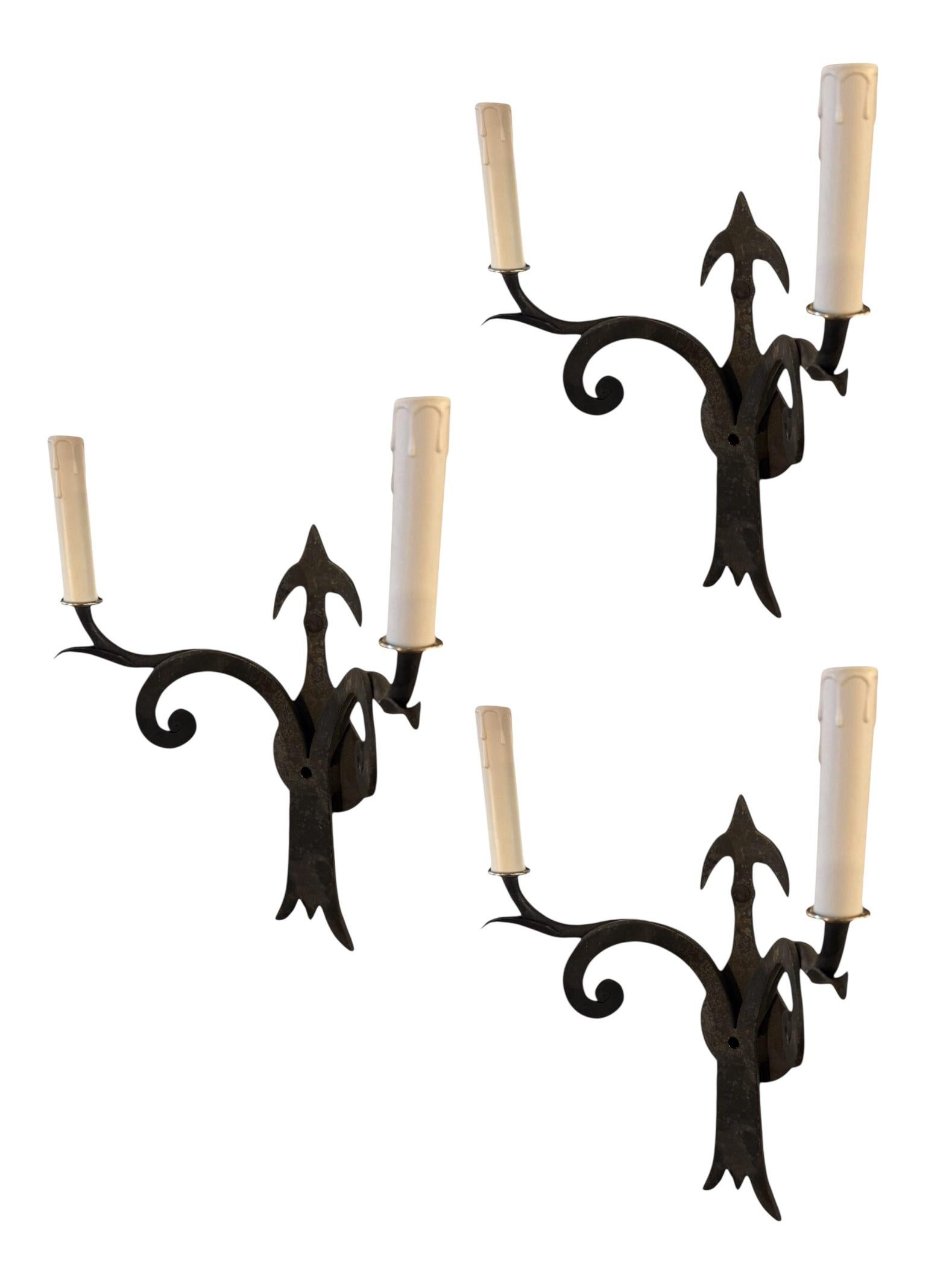Add old-world charm and dramatic flair to your space with this Set of 3 Wrought Iron Spanish Revival Sconces. Expertly hand-forged in the classic tradition of early 20th-century Spanish and Mediterranean design, these sconces feature a timeless