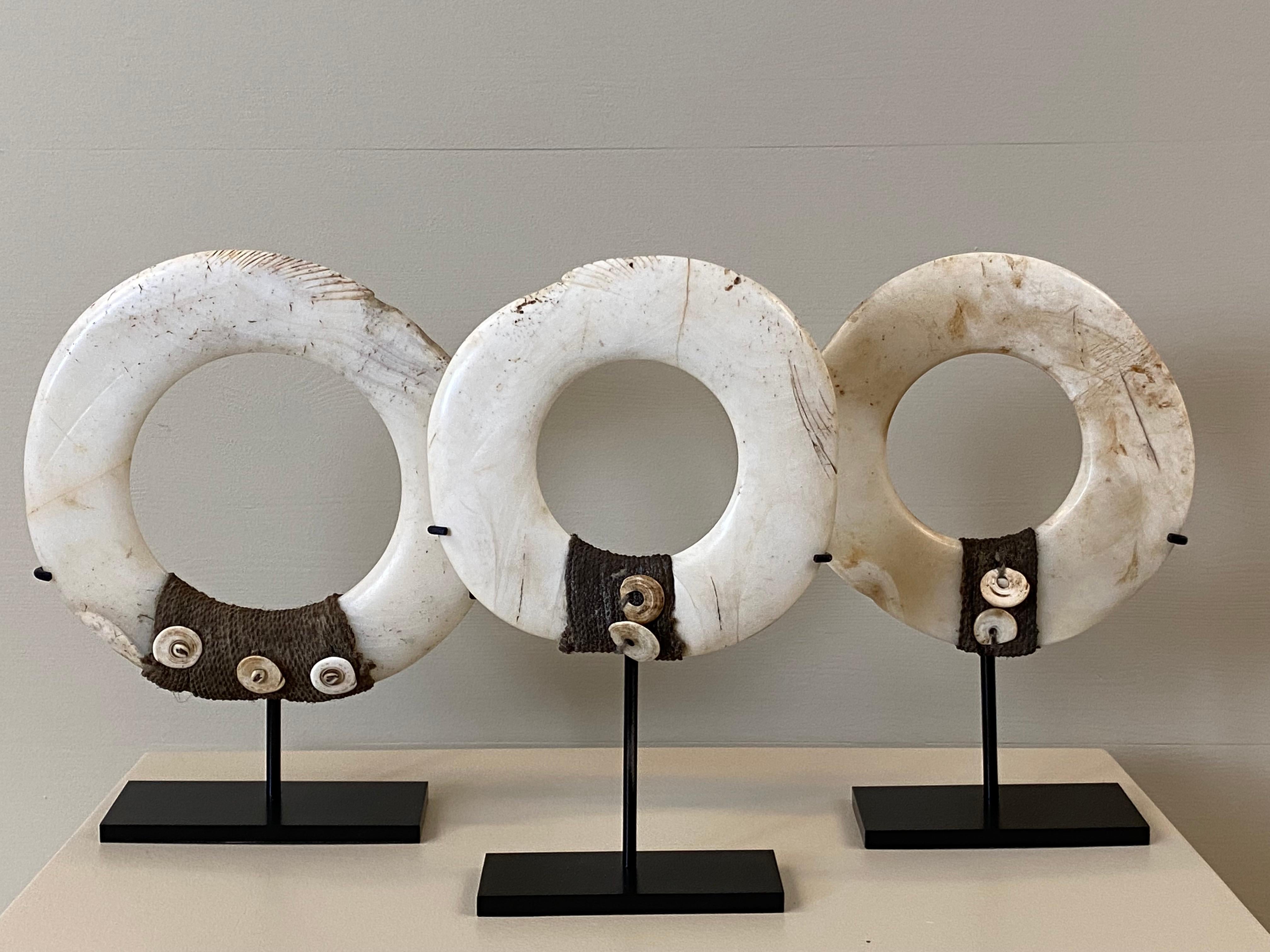 Exceptional set of 3 You Rings from Papua New Guinea
decorated with shells and cords, used as exchange objects
made of the Tridacna Gigas Shell,
different dimensions,
mounted on an iron stand,
32 cm x 26 cm diameter
32 cm x 22 cm diameter
33 cm x 20