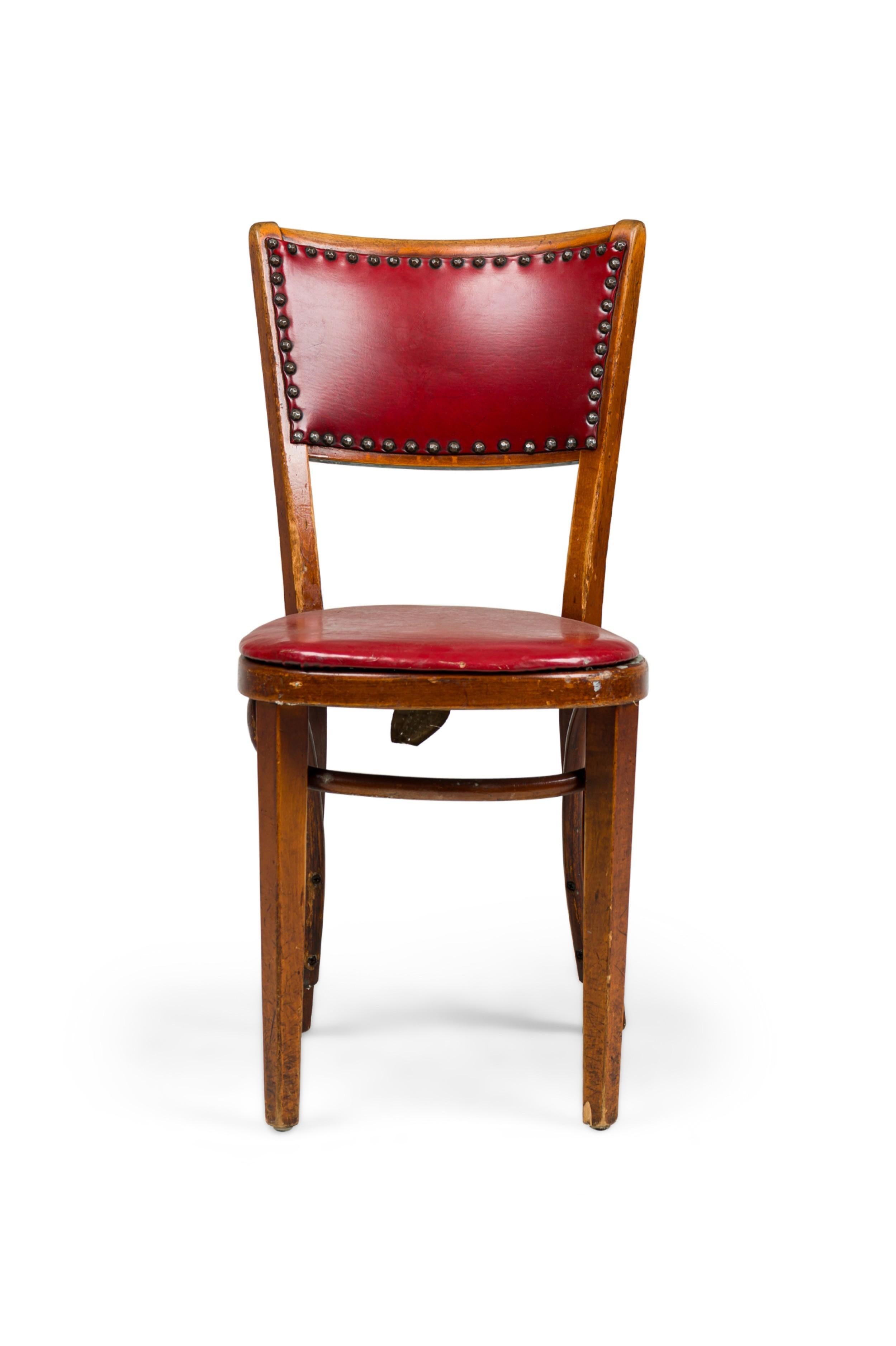 30 American Mid-Century dining side chairs with a red vinyl seat and  back with naihead trim and having a bentwood stretcher (PRICED EACH) (similar set of 18-NWL7232)