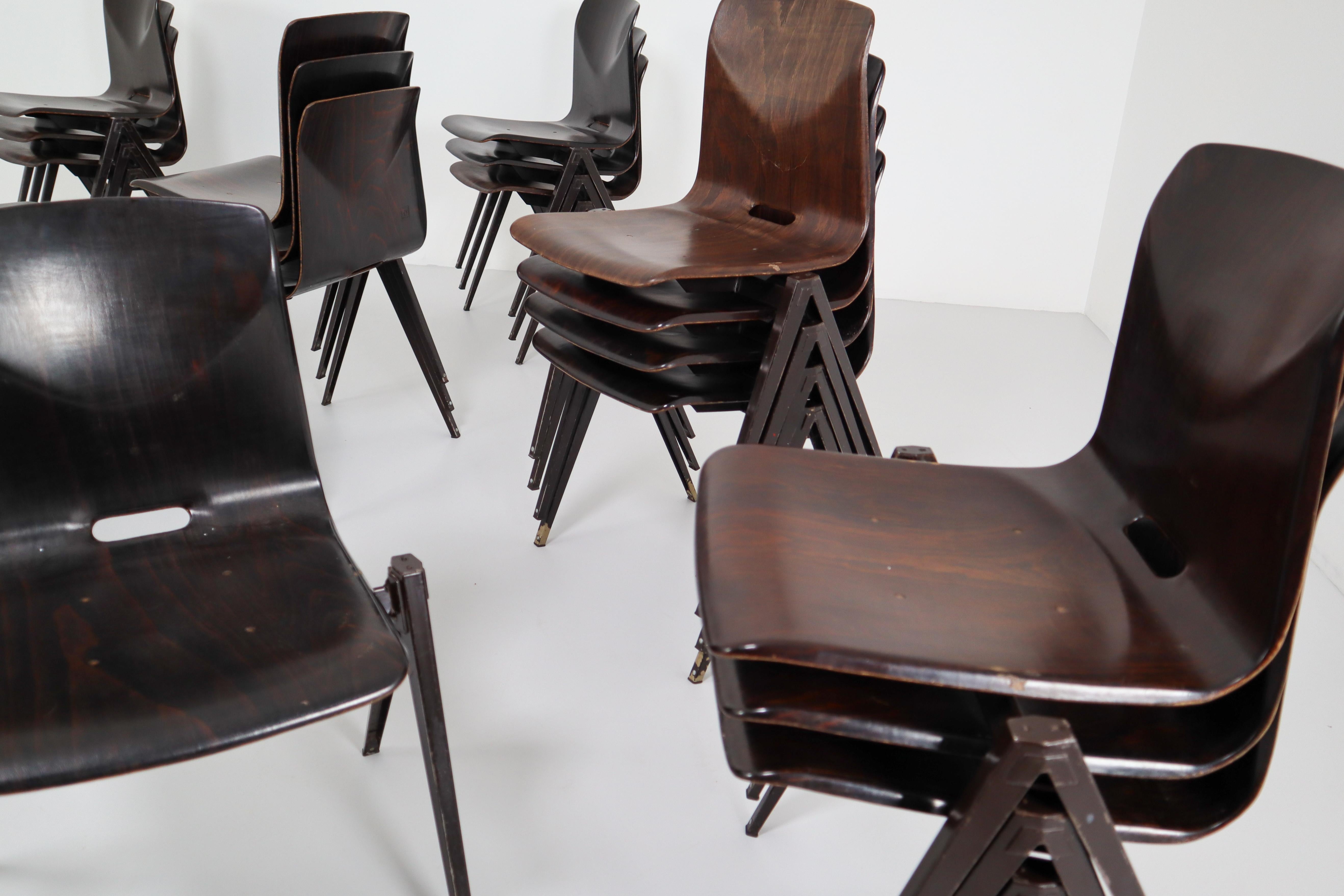 Set of 30 vintage industrial stackable Galvanitas S22 plywood V-leg chair. Black folded and welded steel bases with dark ebony plywood Thur on seat good condition. Slight traces of use.