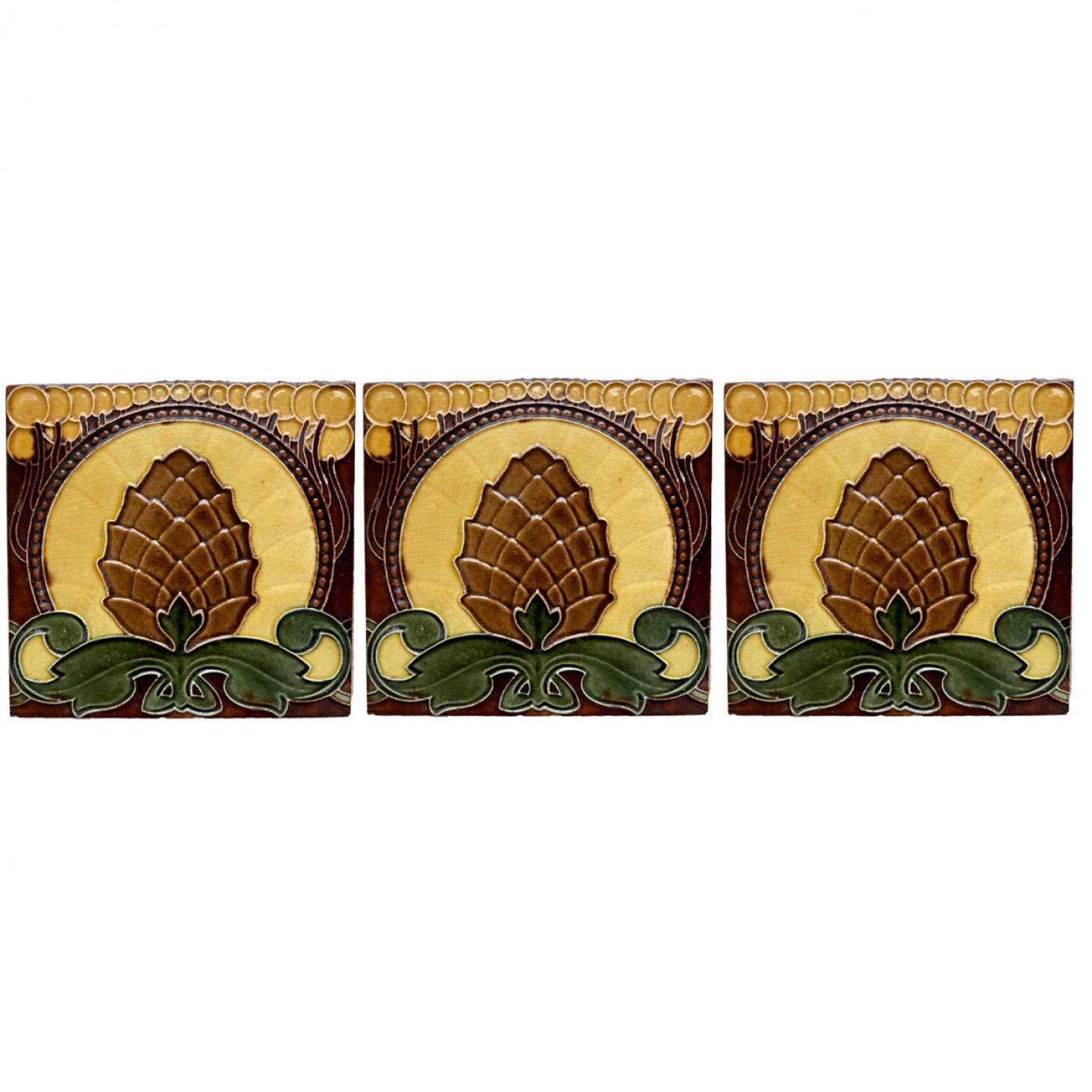 Handmade border tiles in warm yellow, green and brown colors. With an illustration in relief of a pine cone. Manufactured around 1920 by Le Glaive, Belgium.

We have different brown glazed edges (as shown in the images), which complete the