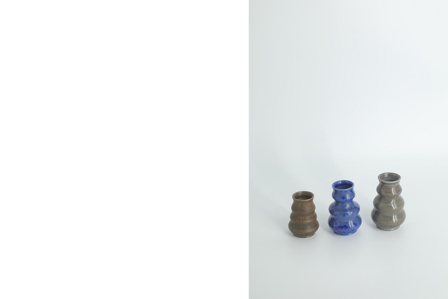 1. Height 8 cm  Width 5 cm  Depth 5 cm
2. Height 7.5 cm  Width 5 cm  Depth 5 cm
3. Height 6 cm  Width 5 cm  Depth 5 cm

This set of 3 miniature vases was designed by Gunnar Borg for the Swedish manufacture Höganäs Keramik during the 1960s. Handmade